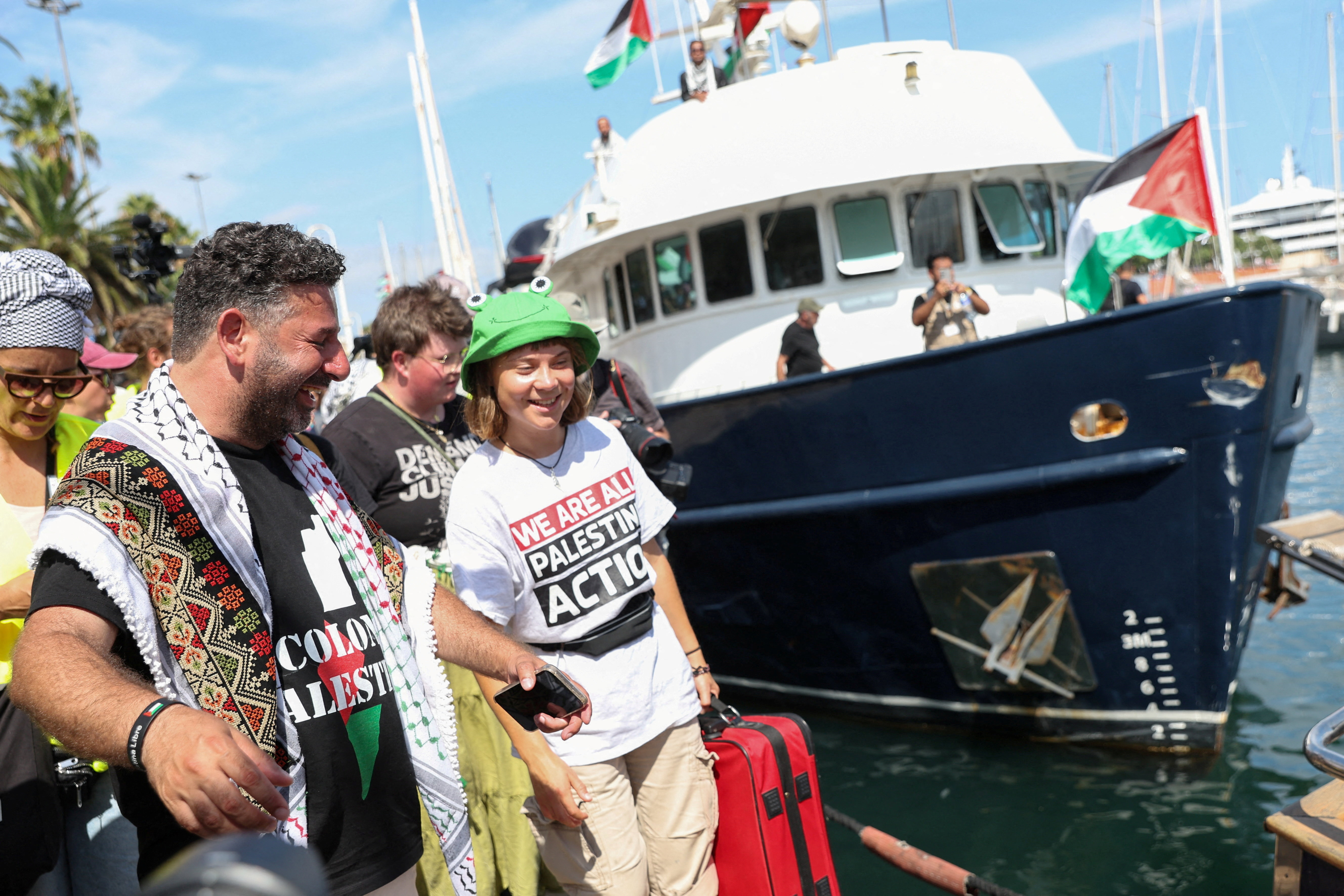 Activists Saif Abukeshek and Greta Thunberg react prior to their departure with other activists on the Global Sumud Flotilla, a humanitarian expedition to Gaza, at the port of Barcelona, Spain August 31, 2025.