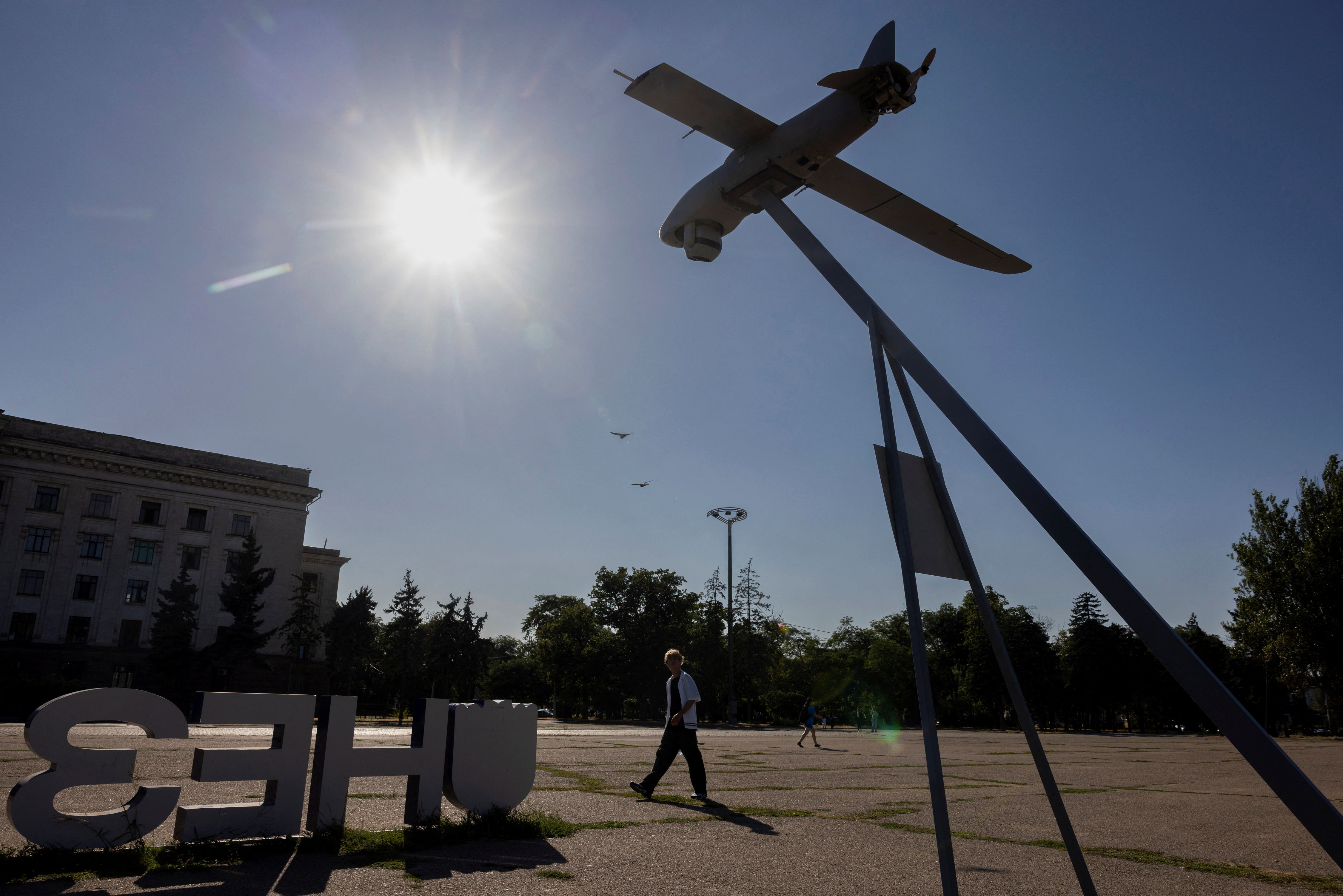 A man walks past a captured Russian surveillance drone on display, amid Russia's attack on Ukraine, in the port city of Odesa, Ukraine August 12, 2025. REUTERS/Thomas Peter