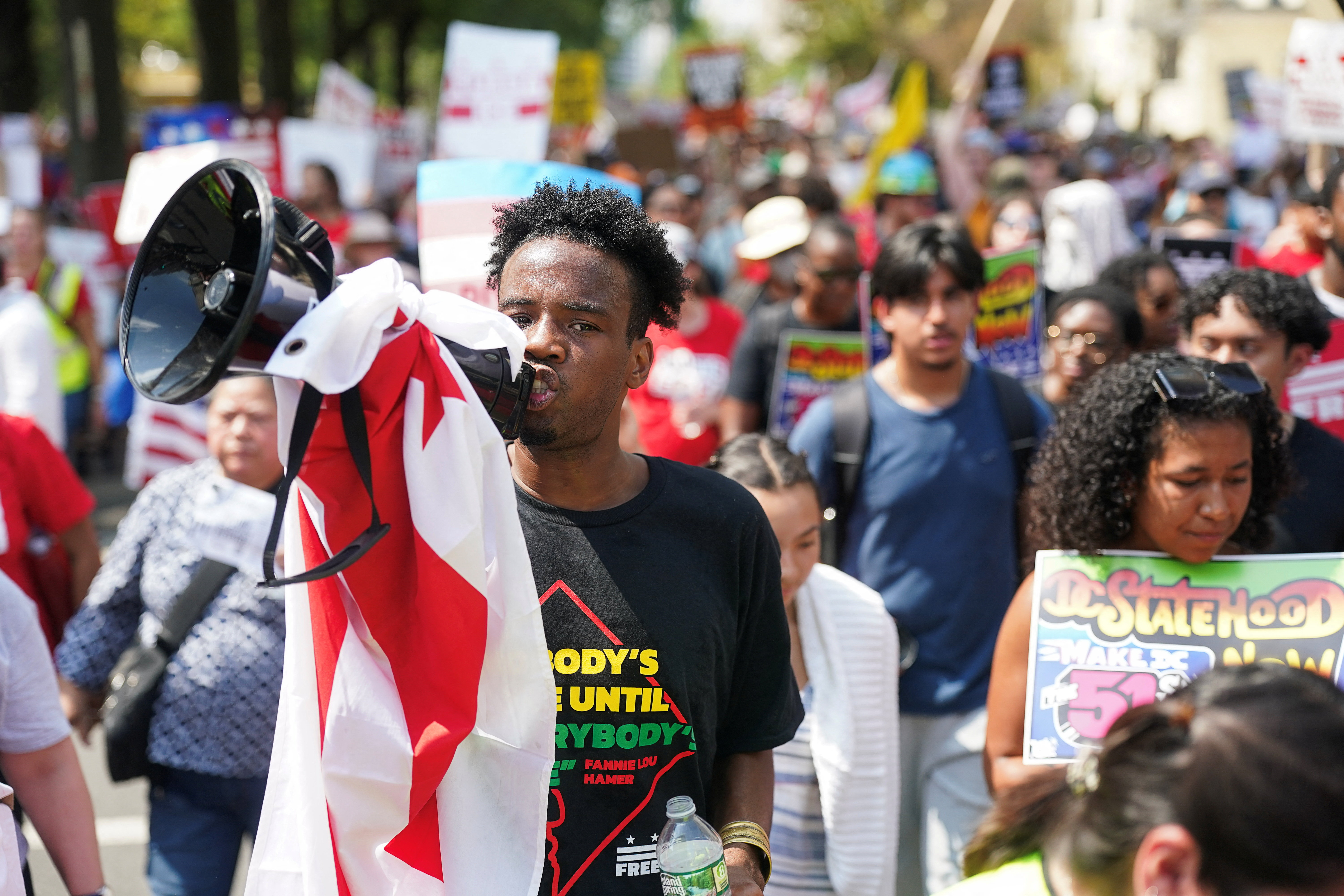 A demonstrator uses a megaphone, during the "We Are All D.C." march to protest against National Guard troops in Washington, D.C., U.S., September 6, 2025.