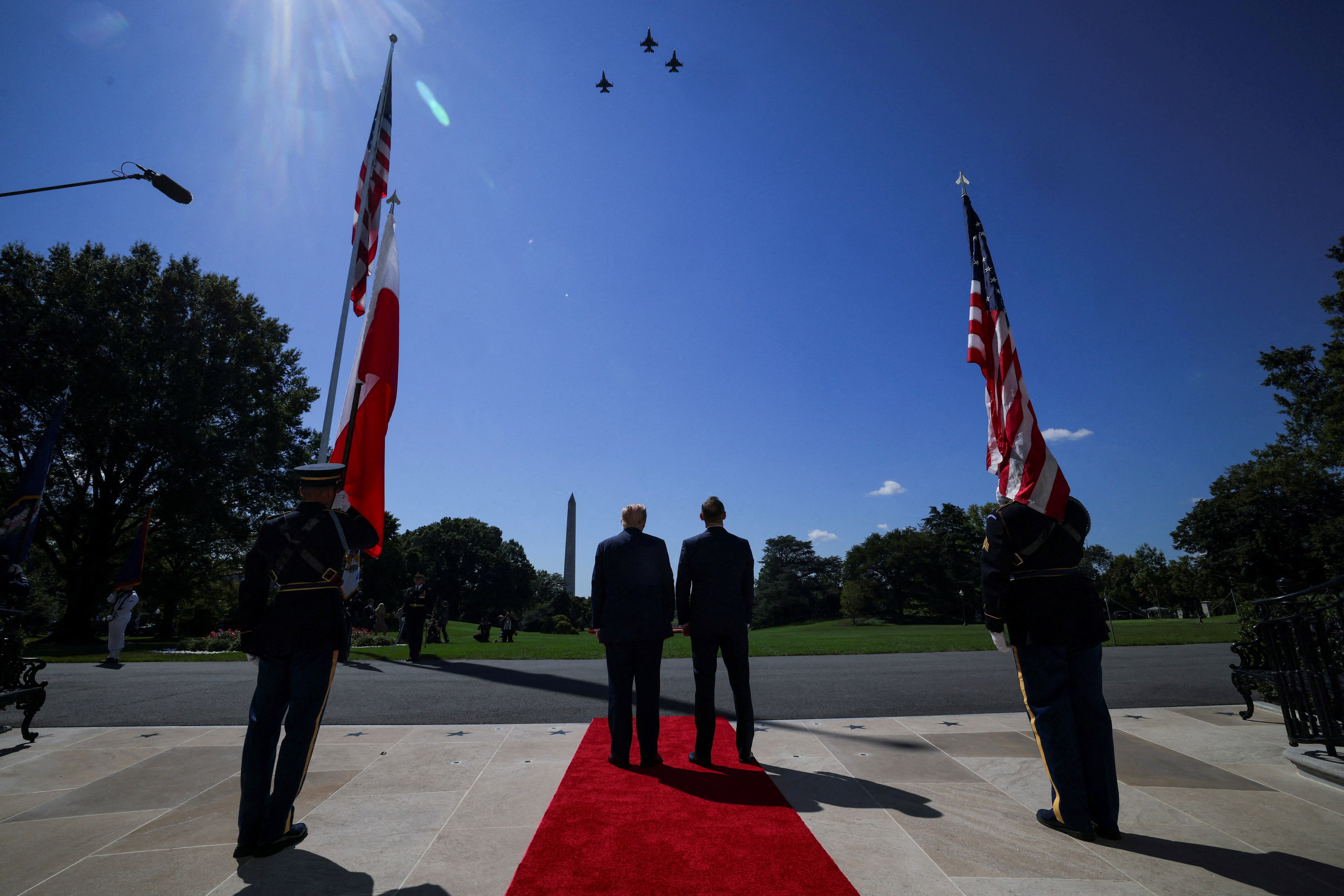 U.S. President Donald Trump and the President of Poland Karol Nawrocki watch a flyover of military planes at the White House in Washington, D.C., U.S., September 3, 2025.