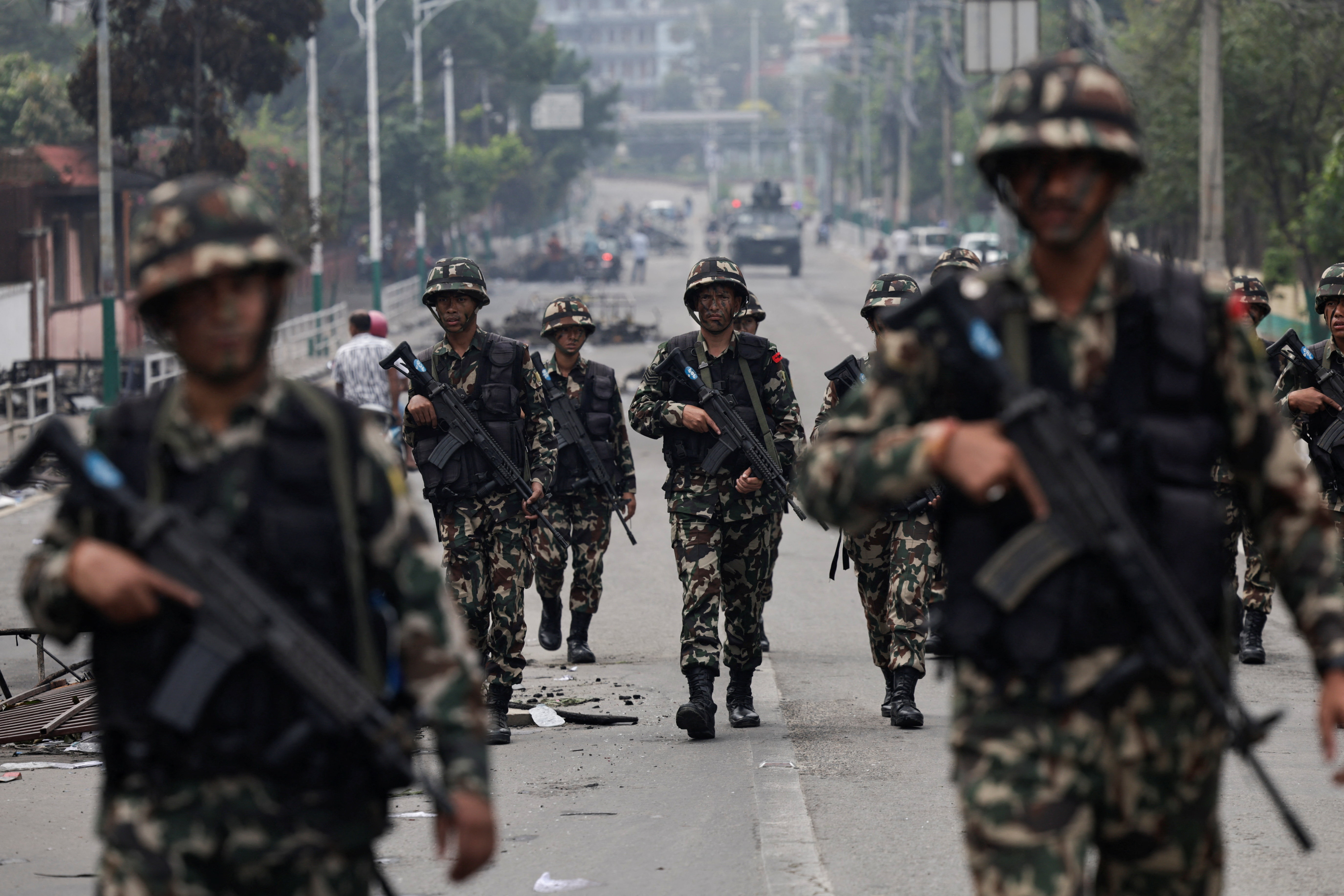 Nepali army soldiers patrol at the road near the Singha Durbar office complex that houses the Prime Minister's office
