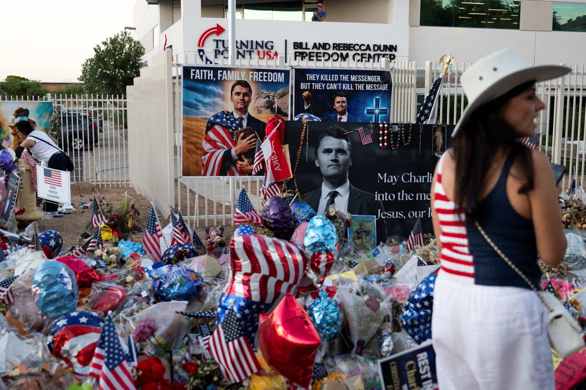 A supporter attends a vigil in memory of right-wing activist Charlie Kirk who was fatally shot during an event at Utah Valley University, outside the headquarters of Turning Point USA in Phoenix, Arizona, U.S. September 19, 2025.  REUTERS/Caitlin O'Hara
