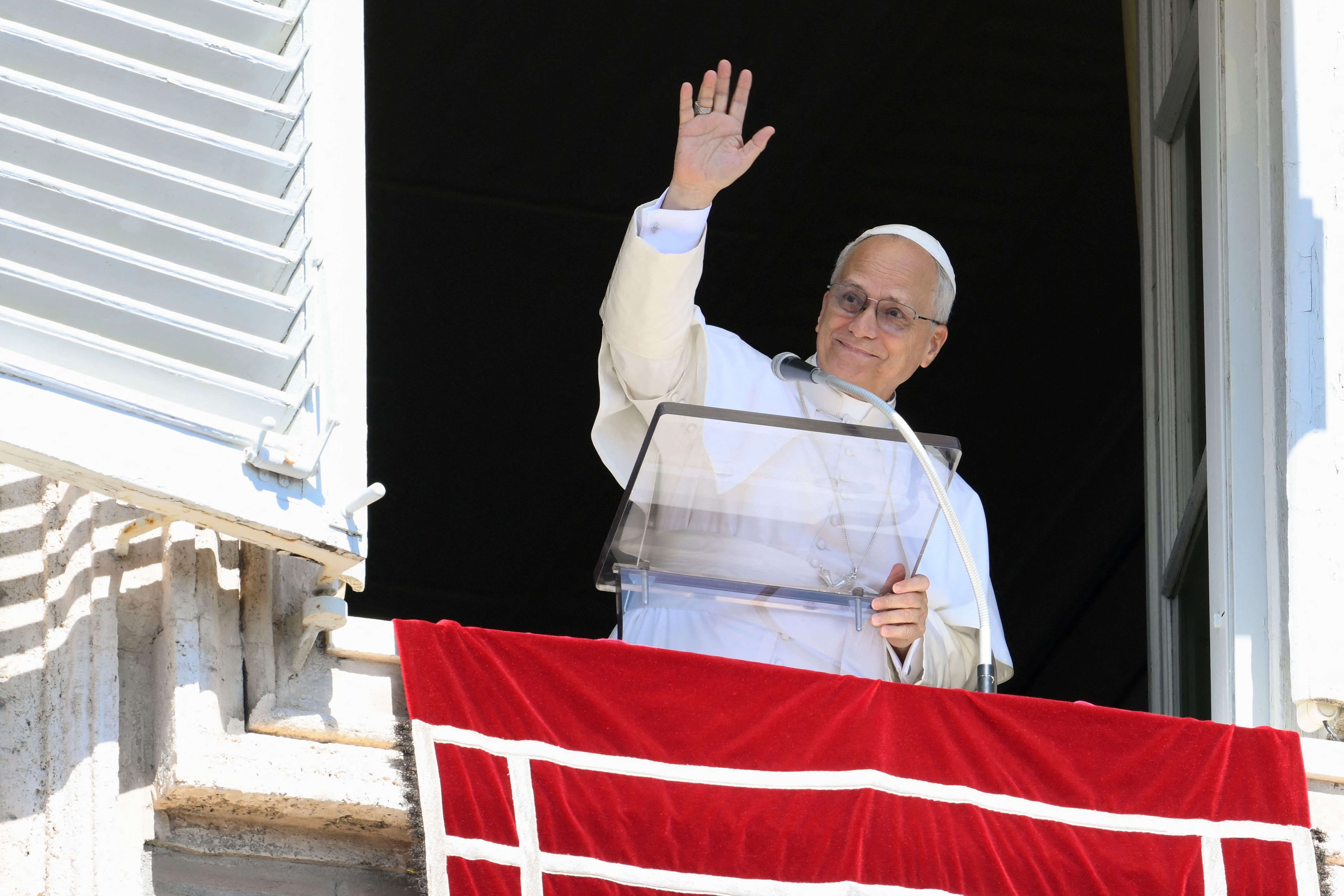 Pope Leo XIV waves as he appears to lead the weekly Angelus prayer, at the Vatican, September 21, 2025.   Vatican Media/Mario Tomassetti/Handout via REUTERS    ATTENTION EDITORS - THIS IMAGE WAS PROVIDED BY A THIRD PARTY.