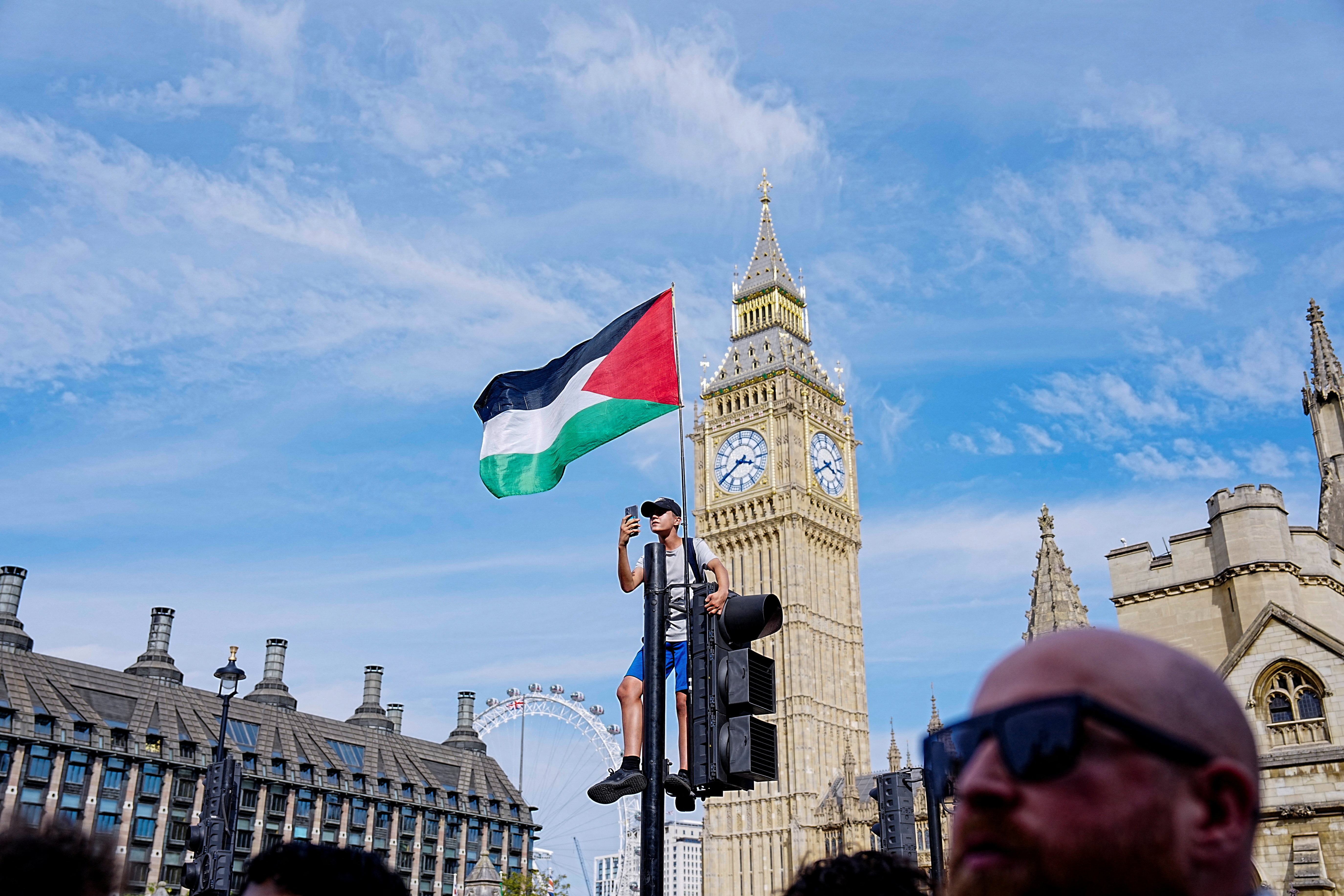 A Palestinian flag is attached to a traffic light on the day of the "Lift The Ban" rally organised by Defend Our Juries,