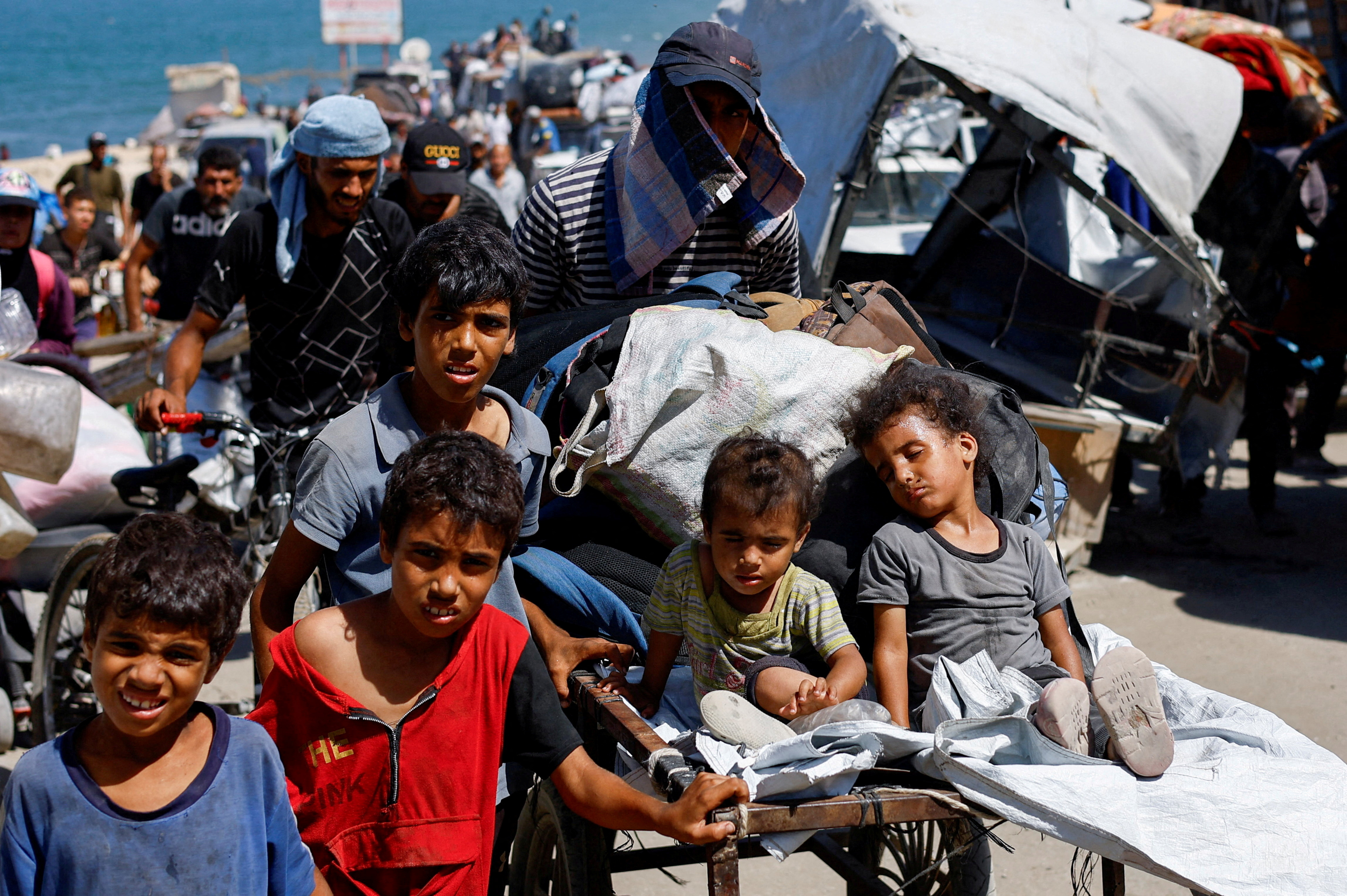 Displaced Palestinian children, part of many fleeing northern Gaza due to an Israeli military operation, move southward, after Israeli forces ordered residents of Gaza City to evacuate to the south