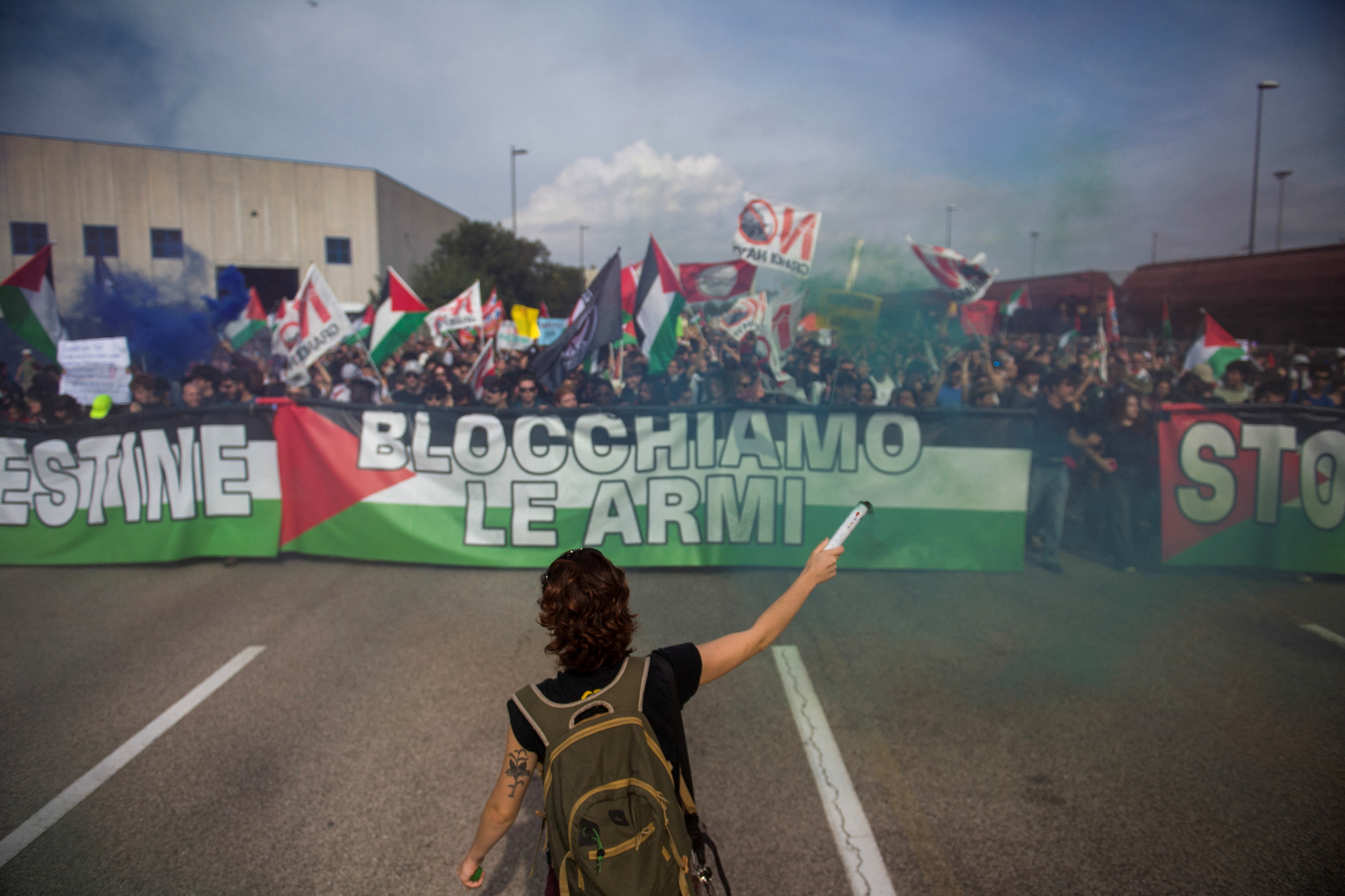 Protesters hold banners and Palestinian flags during a demonstration that is part of a nationwide "Let's Block Everything" protest in solidarity with Gaza, with activists also calling for a halt to arms shipments to Israel,