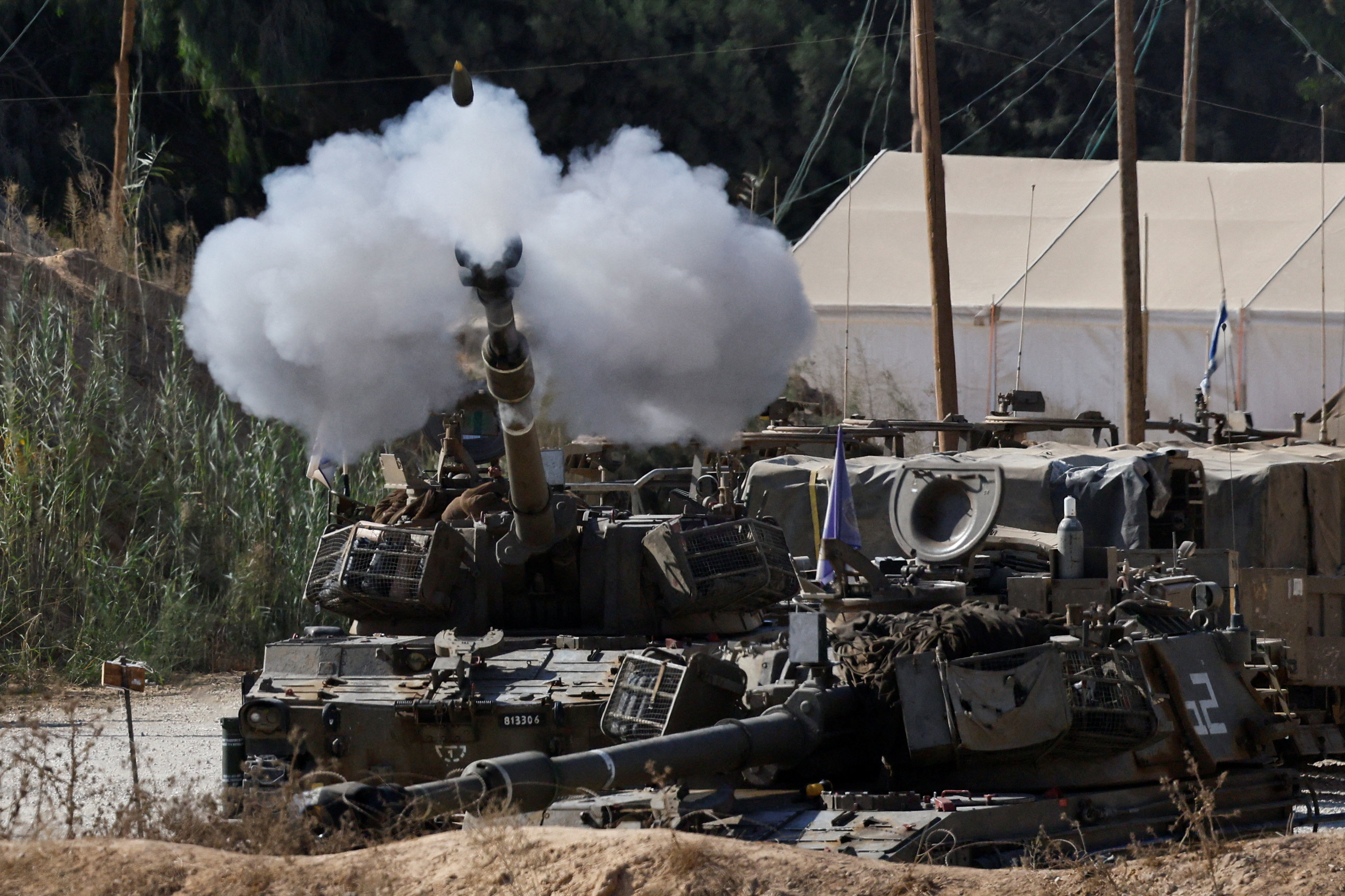 An Israeli mobile artillery unit fires towards Gaza near the Israel-Gaza border, in Israel