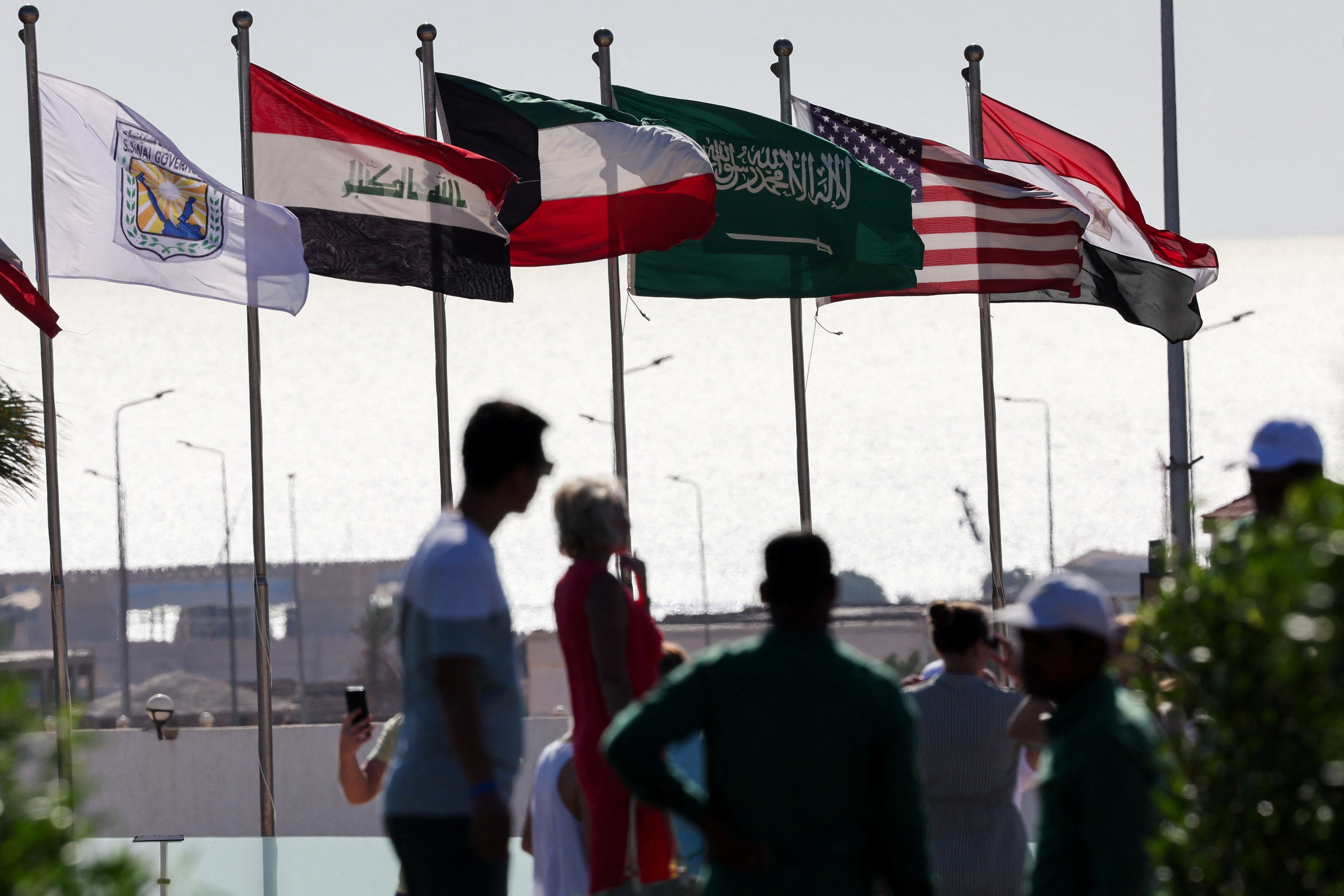 People visit the Peace Square, as flags flutter, ahead of an international summit on Gaza, held amid a ceasefire between Israel and Hamas, at Egypt's Red Sea resort of Sharm el-Sheikh, Egypt, October 12, 2025. REUTERS/Amr Abdallah Dalsh