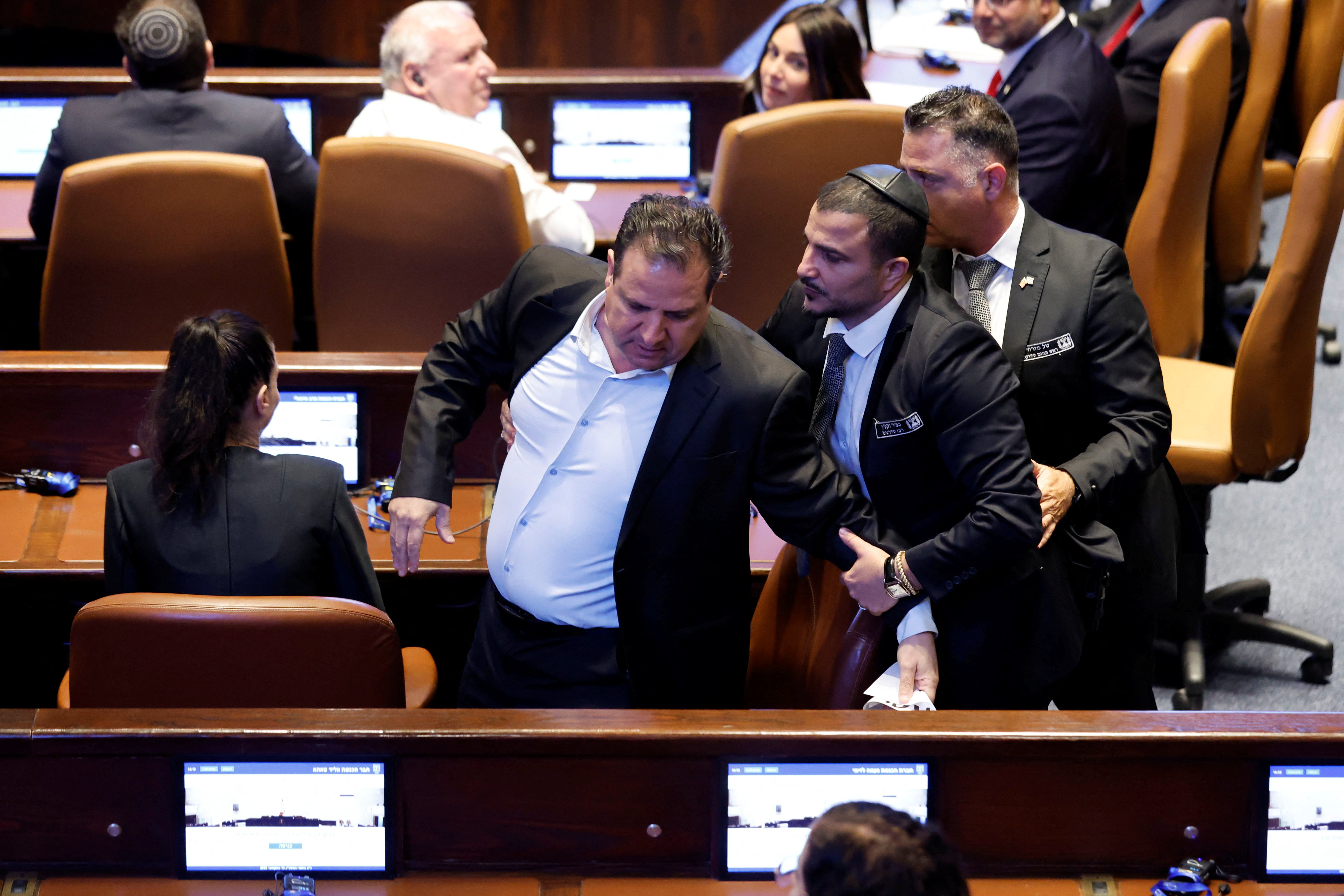 Knesset member Ayman Odeh is removed from the hall after raising a sign while U.S. President Donald Trump addresses the Knesset, Israel’s parliament, on October 13, 2025 in Jerusalem.