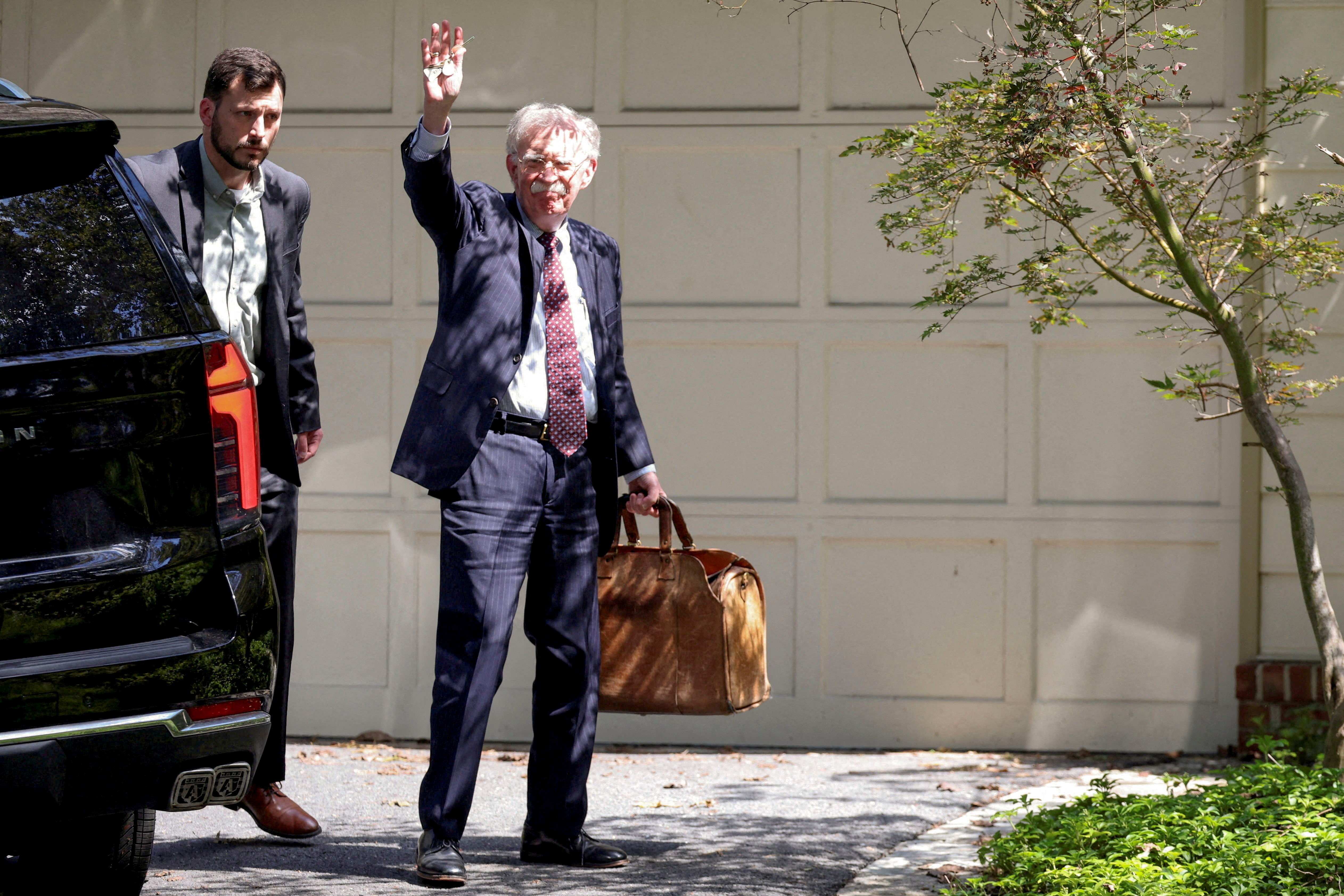 FILE PHOTO: Former White House national security adviser John Bolton arrives at his house following its search by the FBI in Bethesda, Maryland, U.S., August 22, 2025. REUTERS/Tasos Katopodis/File Photo