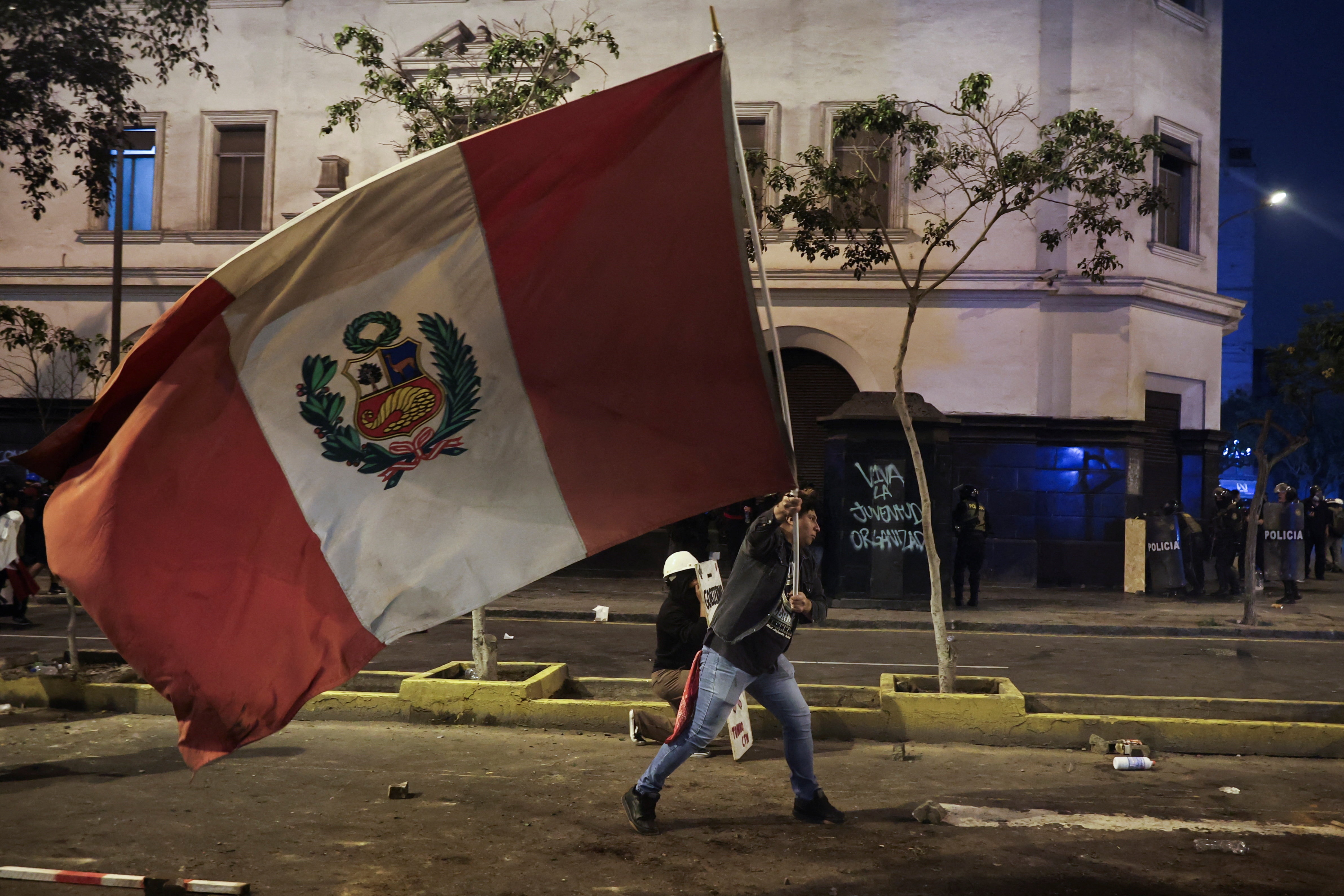 A demonstrator waves a Peruvian flag during a protest against rising crime, economic insecurity, and corruption, a day after President Jose Jeri presented his cabinet, in Lima, Peru, October 15, 2025. REUTERS/Sebastian Castaneda