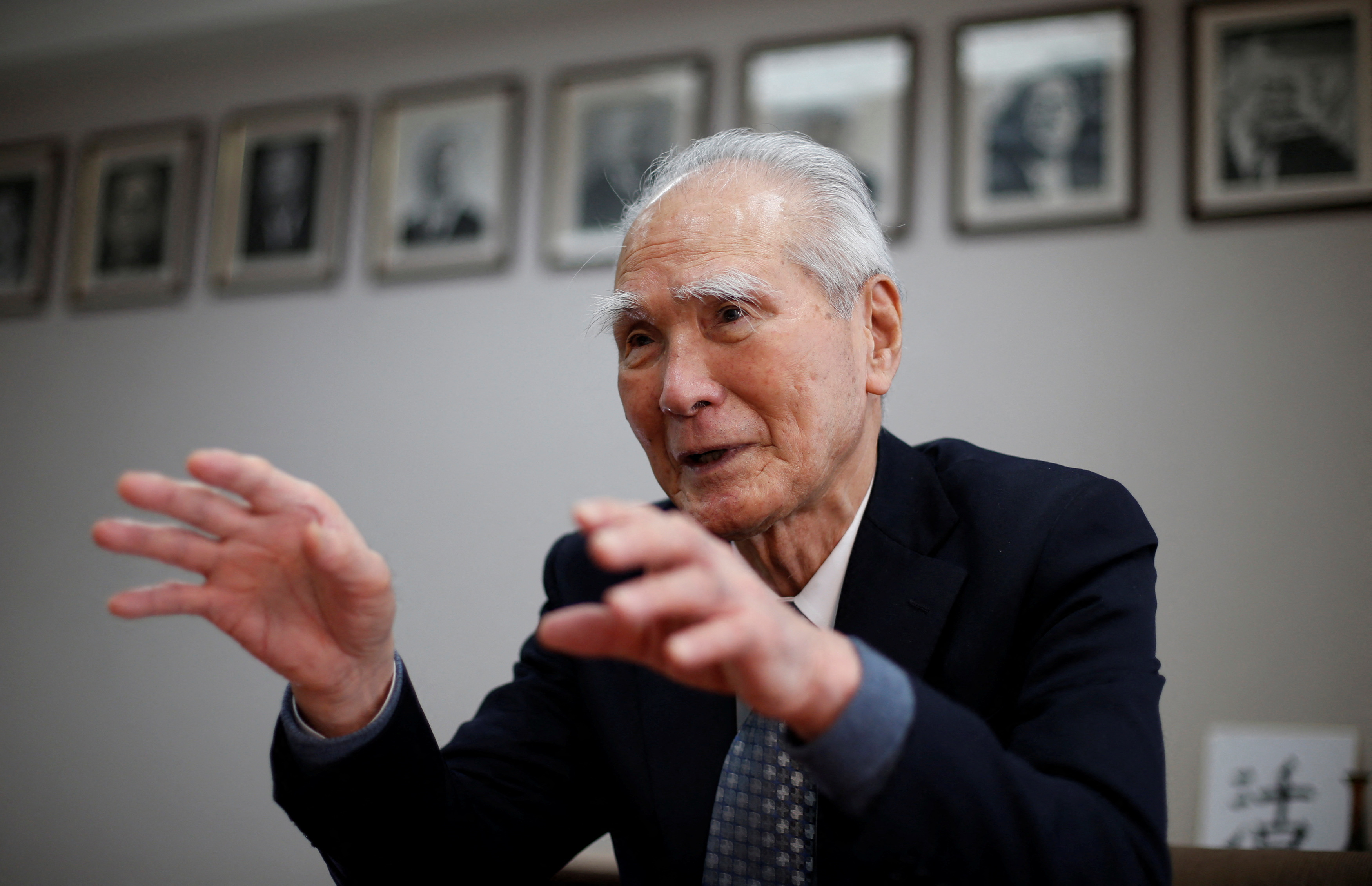 FILE PHOTO: Former Japanese Prime Minister Tomiichi Murayama speaks in front of portraits of former leaders of his Social Democratic Party