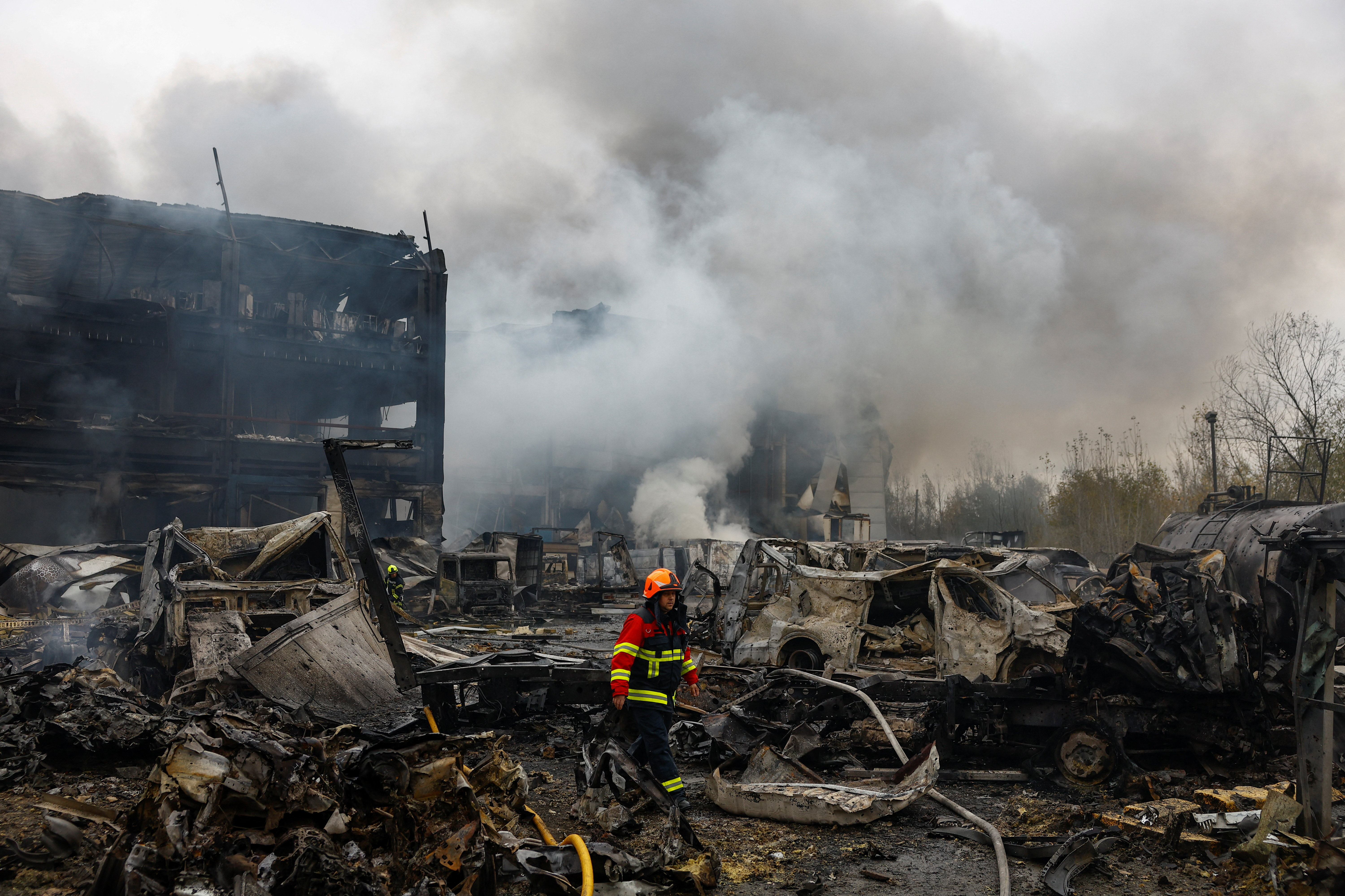 A firefighter walks at the site of food warehouses hit by an overnight Russian missile strike, amid Russia’s attack on Ukraine, in Kyiv, Ukraine October 25, 2025. REUTERS/Valentyn Ogirenko