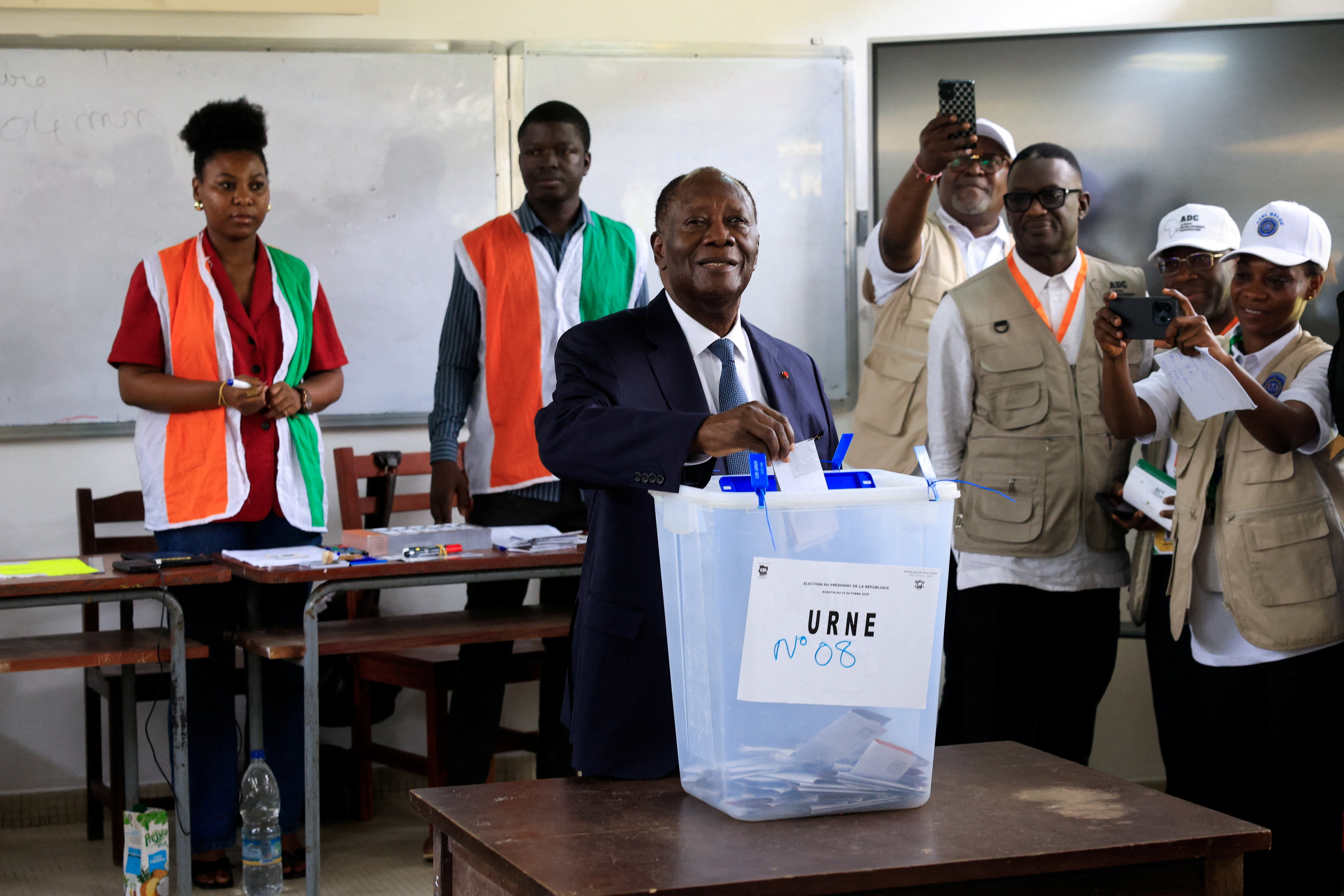 Ivory Coast's President Alassane Ouattara, who is seeking a fourth term, votes during the presidential election