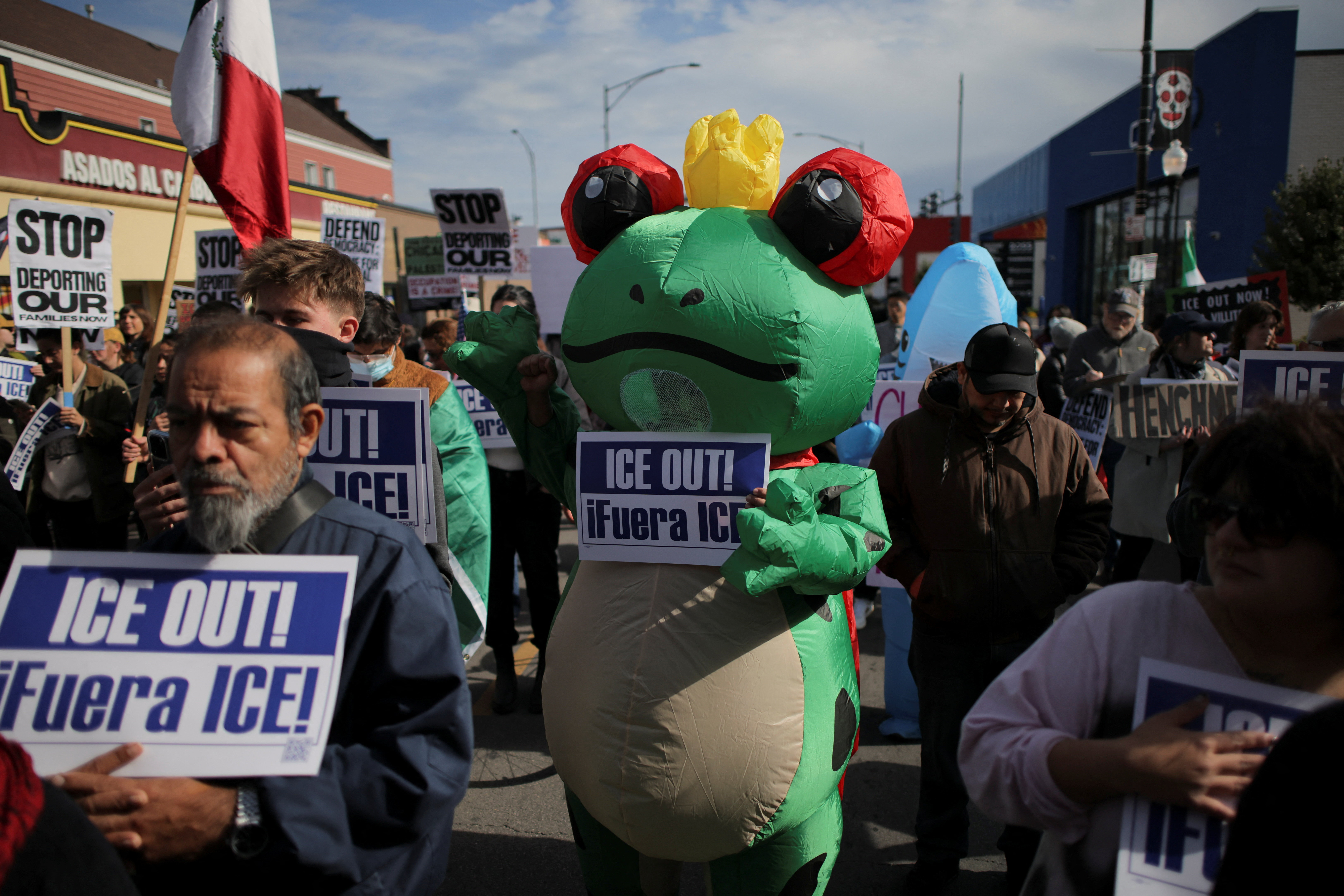 A demonstrator wears an inflatable costume during a protest against ICE raids, in Little Village, Chicago, Illinois, U.S., October 24, 2025. REUTERS/Daniel Cole