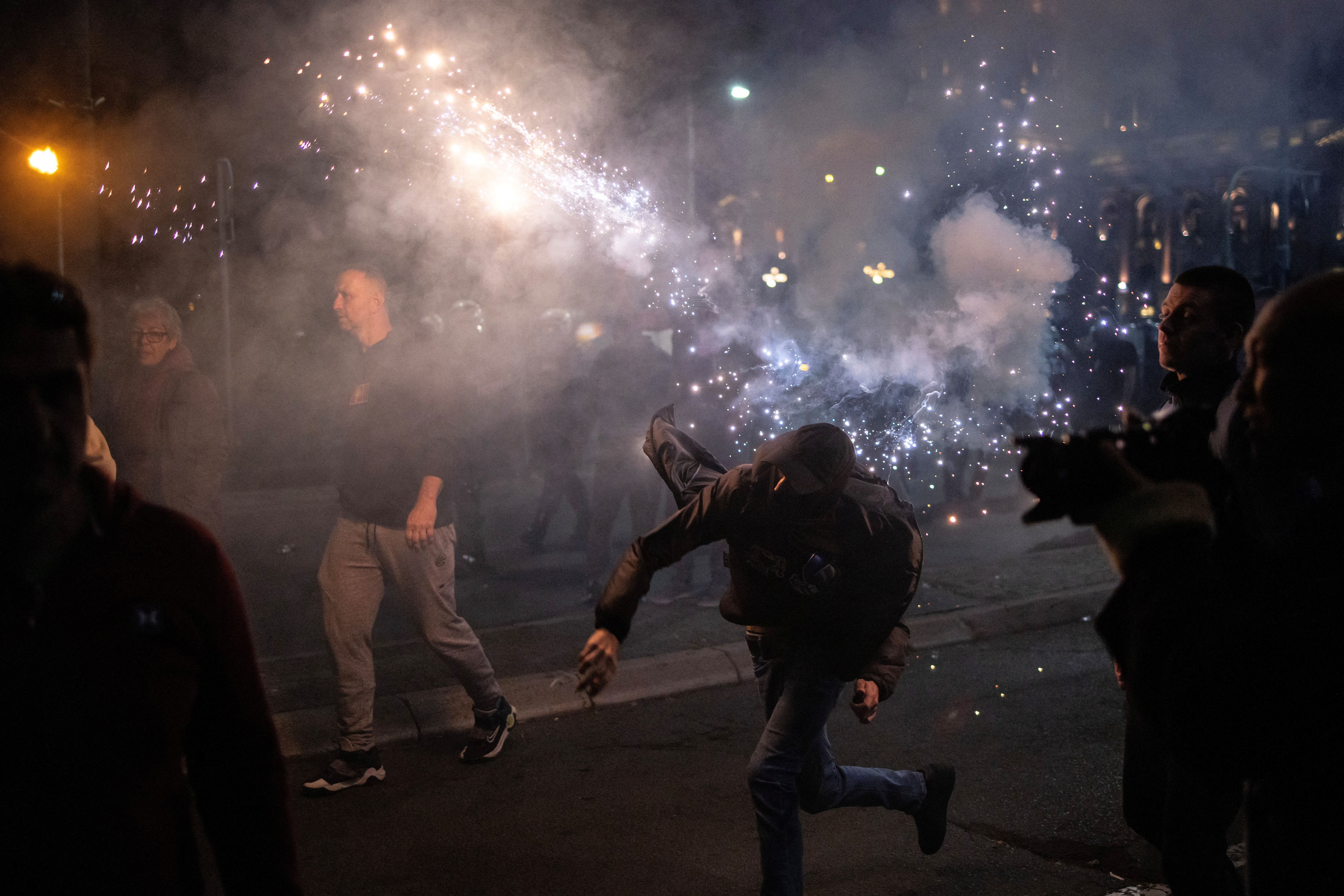 An anti-government demonstrator throws a flare during a protest near the parliament building in Belgrade, Serbia, November 2, 2025. REUTERS/Marko Djurica