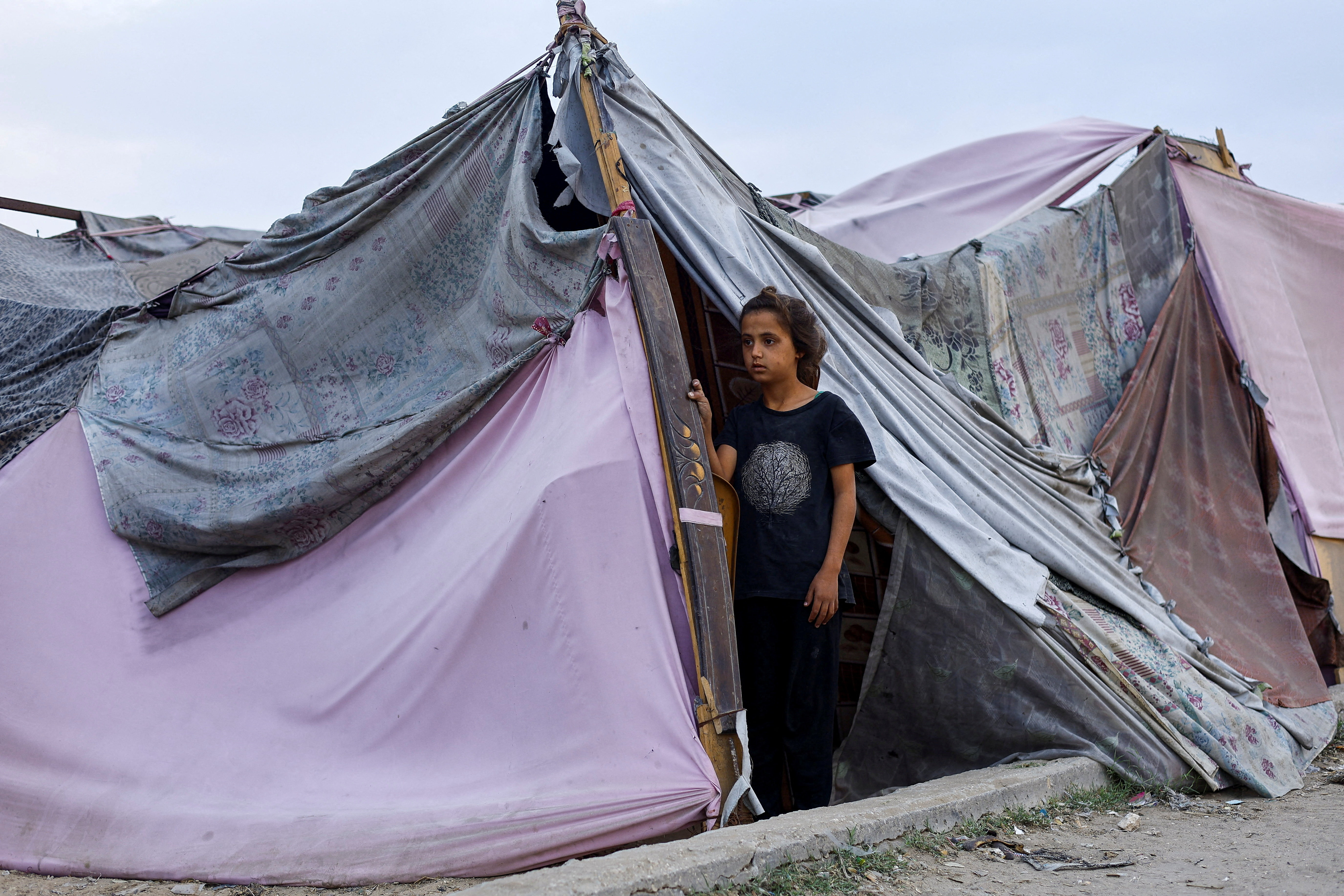 A displaced Palestinian girl looks out of a tent amid a ceasefire between Israel and Hamas, in Gaza City, November 4, 2025.     TPX IMAGES OF THE DAY