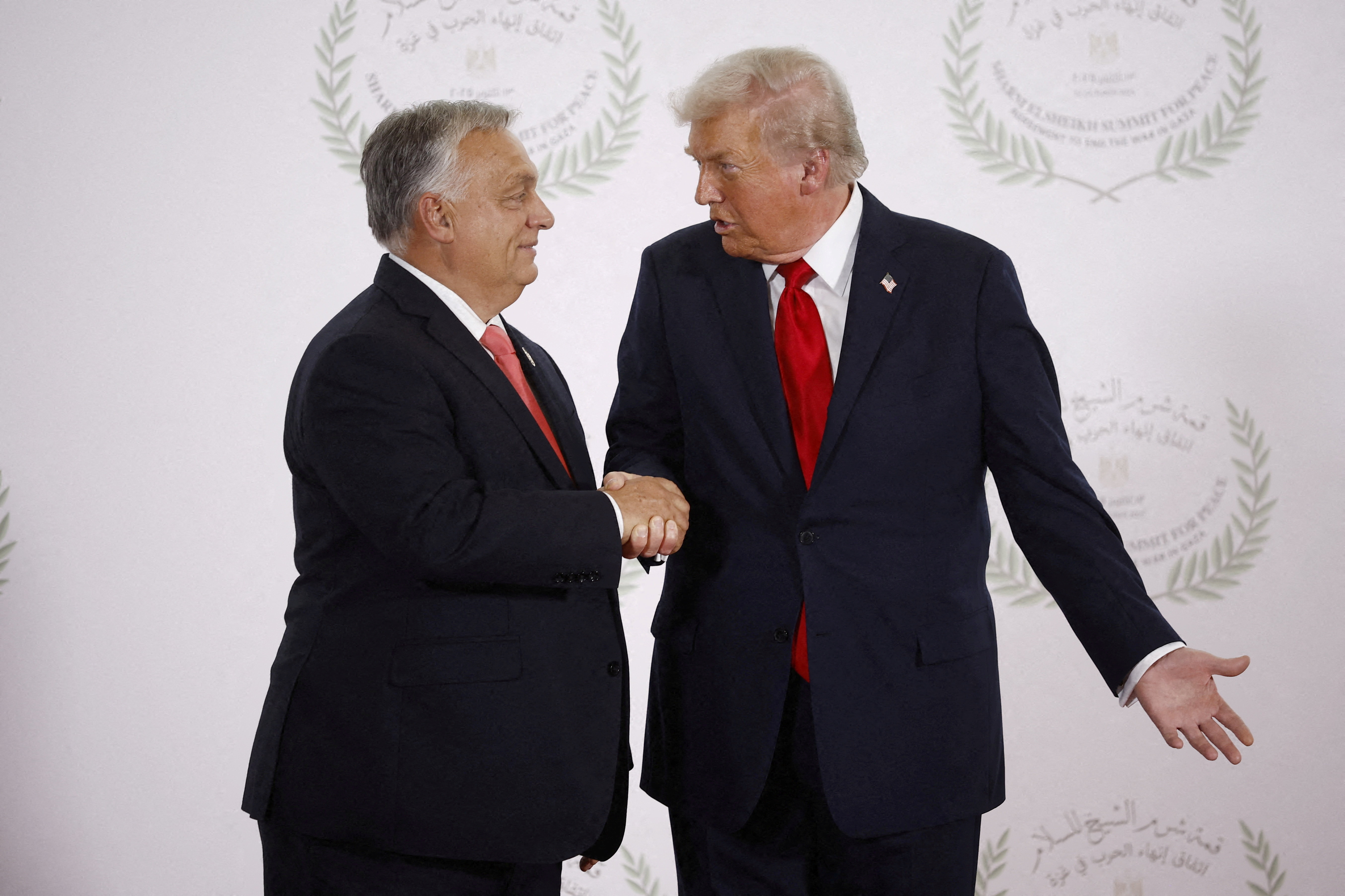 FILE PHOTO: U.S. President Donald Trump and Hungary's Prime Minister Viktor Orban shake hands as they pose for a photo, at a world leaders' summit on ending the Gaza war in Sharm el-Sheikh, Egypt, October 13, 2025. Yoan Valat/Pool via REUTERS/File Photo