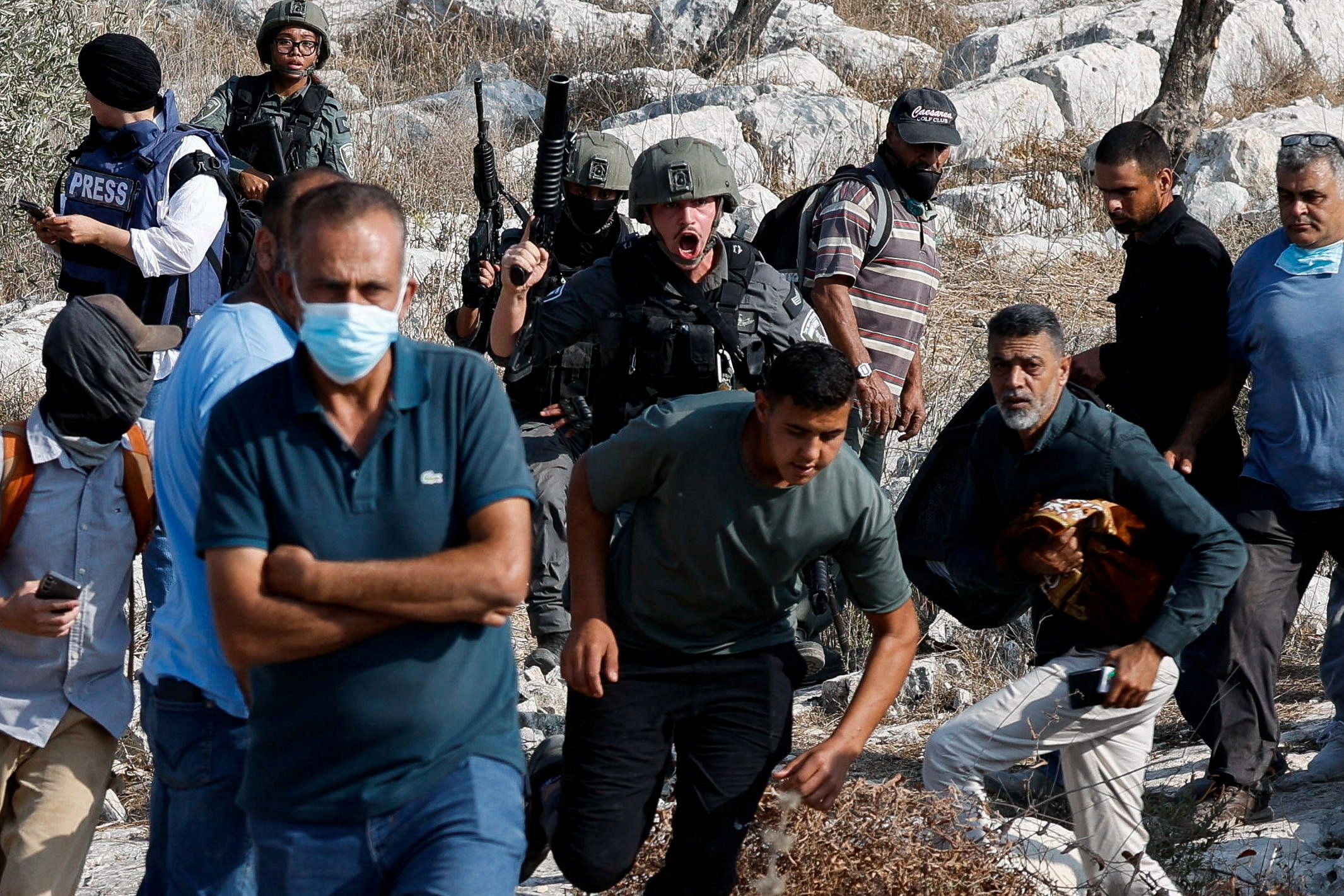 An Israeli soldier shouts at Palestinian protesters who went out to pray on their land, threatened by Israeli settlement expansion, in Beit Lid, near Tulkarm, in the Israeli-occupied West Bank, November 7, 2025.