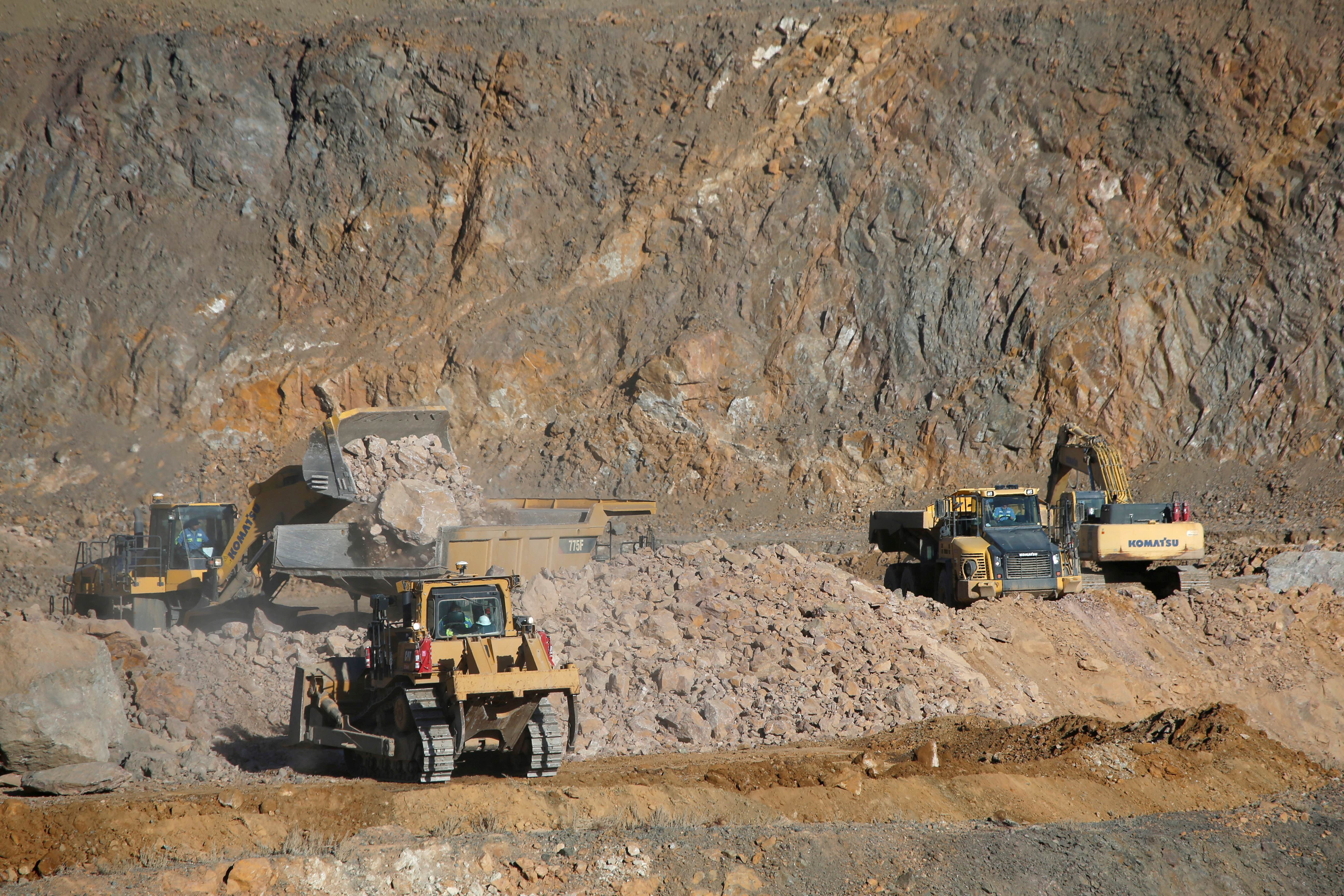 FILE PHOTO: Wheel loaders fill trucks with ore at the MP Materials rare earth mine in Mountain Pass, California, U.S. January 30, 2020.  REUTERS/Steve Marcus/File Photo