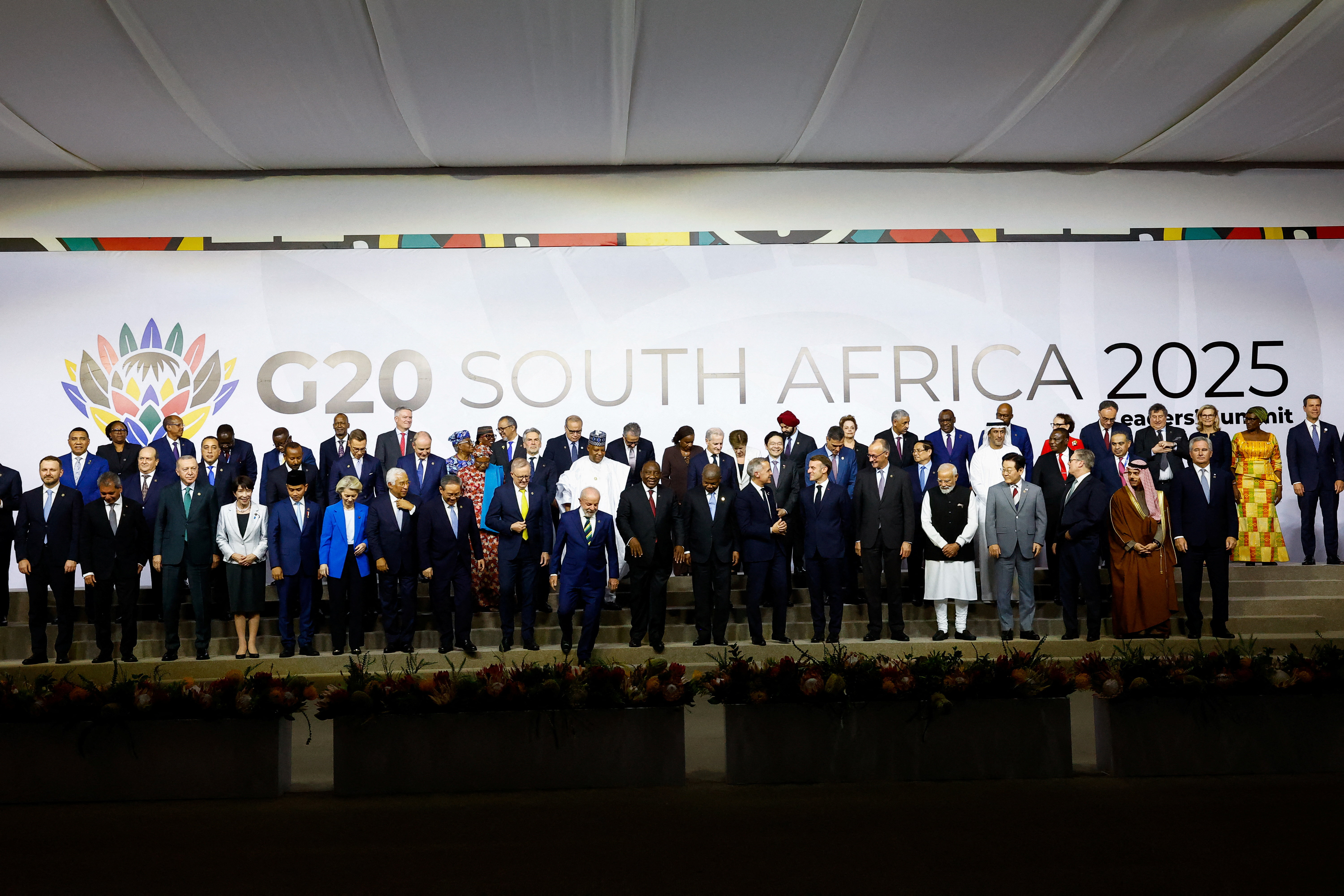 Leaders and delegates attend a family photo event, on the opening day of the G20 Leader's Summit at the Nasrec Expo Centre in Johannesburg, South Africa, November 22, 2025. REUTERS/Thomas Mukoya/Pool