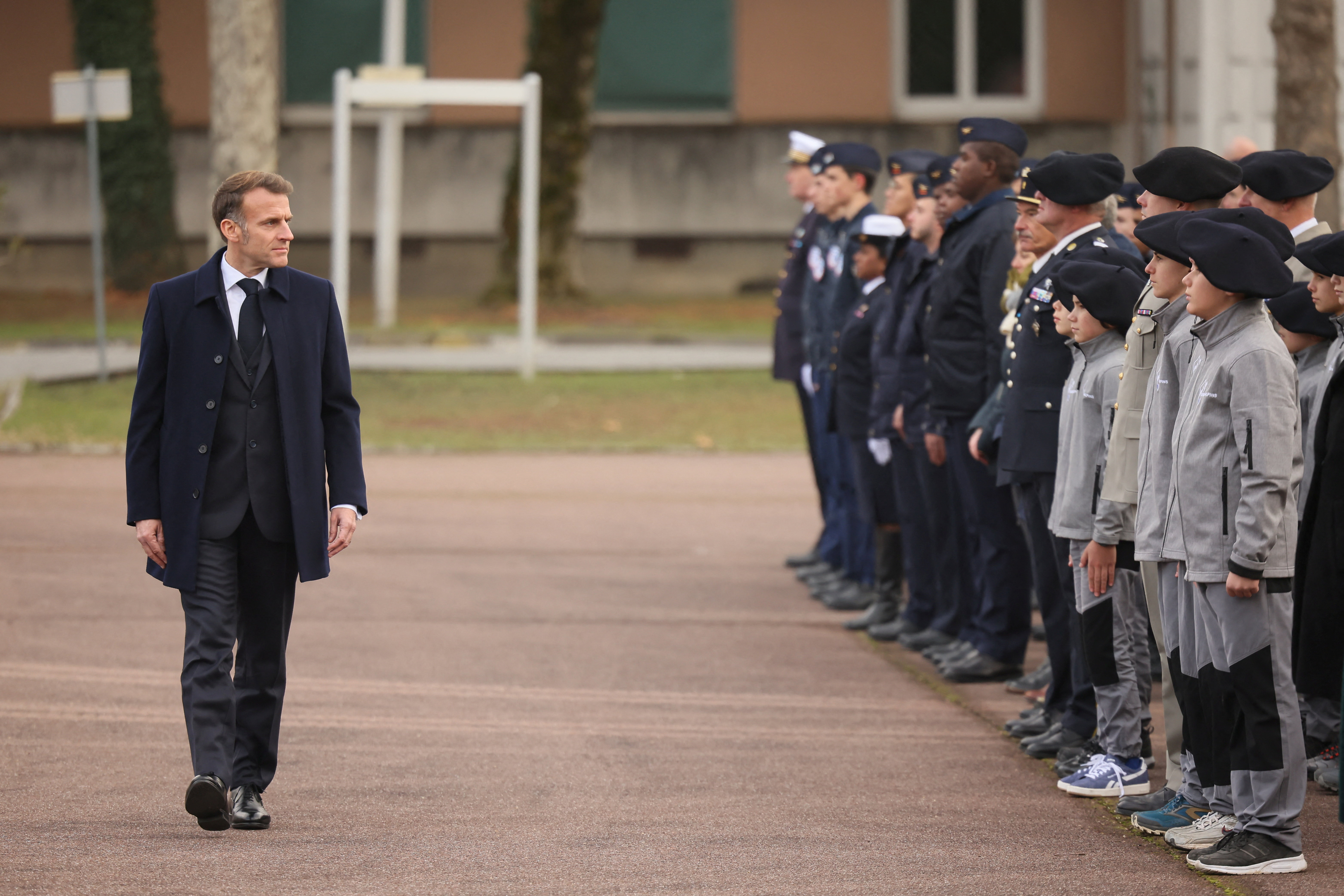 France's President Emmanuel Macron reviews troops and students of an army high school prior to his speech to unveil a new national military service at the military base in Varces, French Alps,  November 27, 2025.