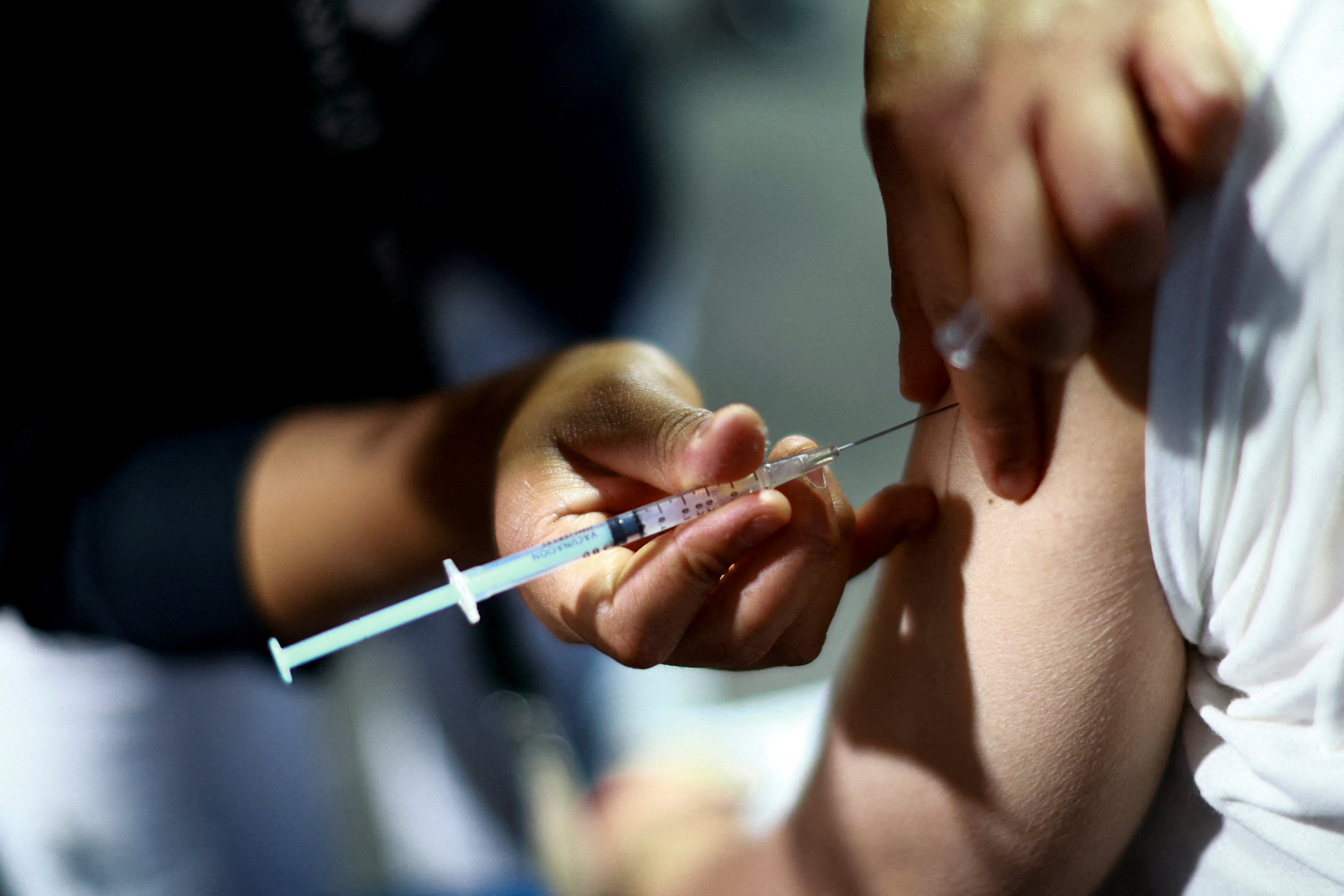 FILE PHOTO: A nurse administers a dose of the measles vaccine to a man during a vaccination campaign in response to a measles outbreak, at the Estadio Olimpico Universitario in Mexico City, Mexico, November 12, 2025. REUTERS/Raquel Cunha/File Photo