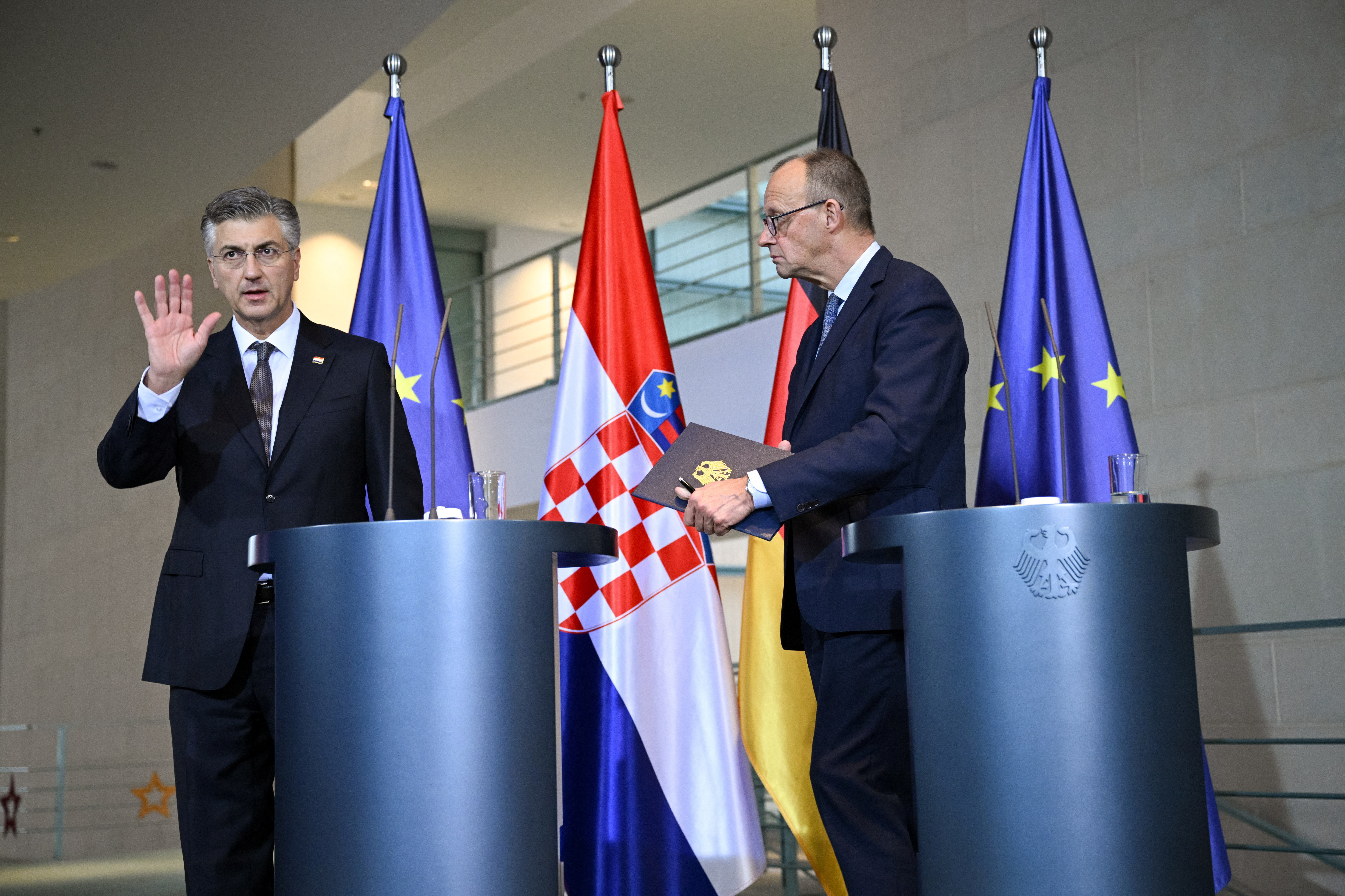 Croatian Prime Minister Andrej Plenkovic gestures at the end of a press conference with German Chancellor Friedrich Merz at the Chancellery in Berlin