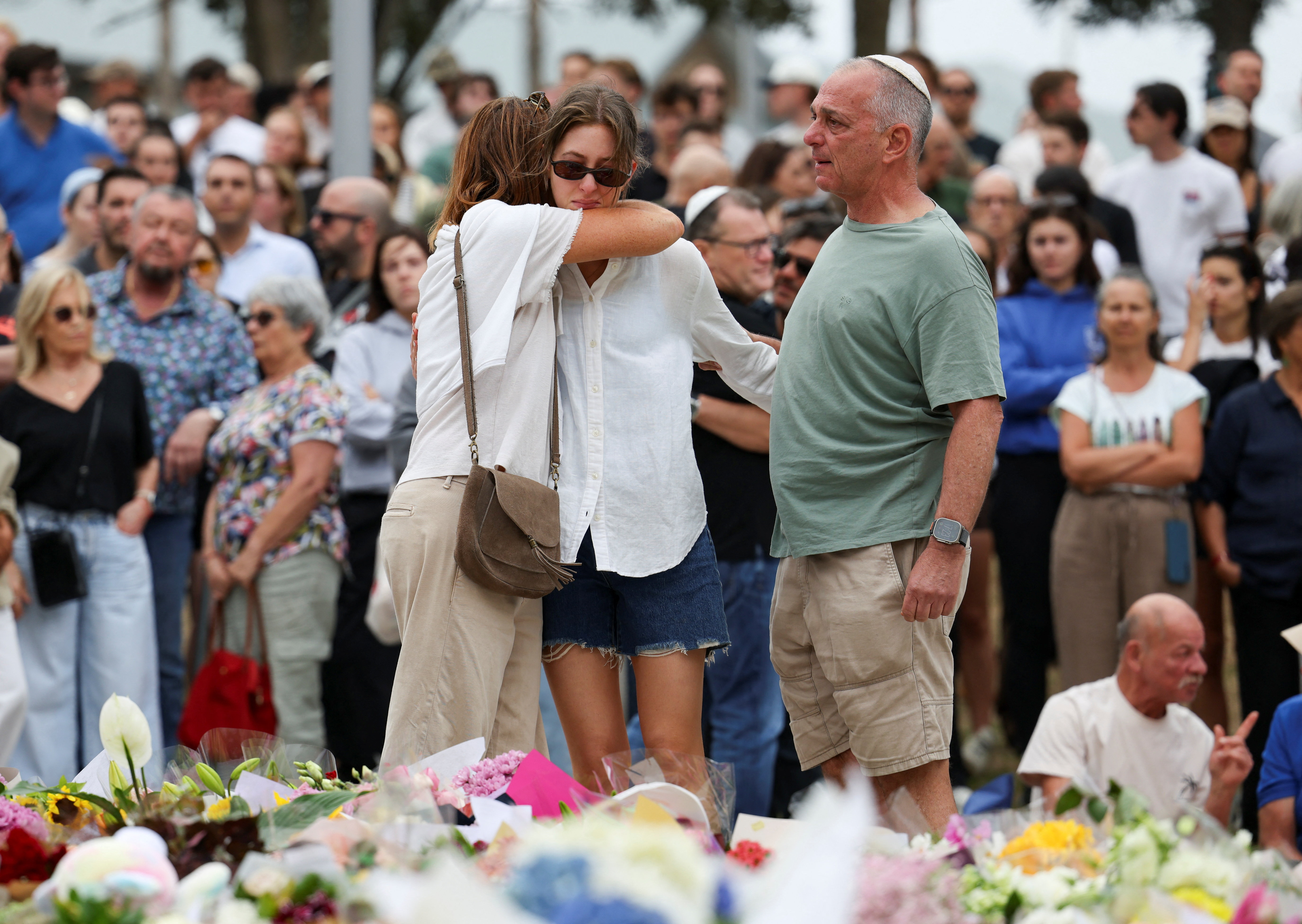 People pay respects at Bondi Pavilion to victims of a shooting during a Jewish holiday celebration at Bondi Beach, in Sydney, Australia, December 15, 2025.