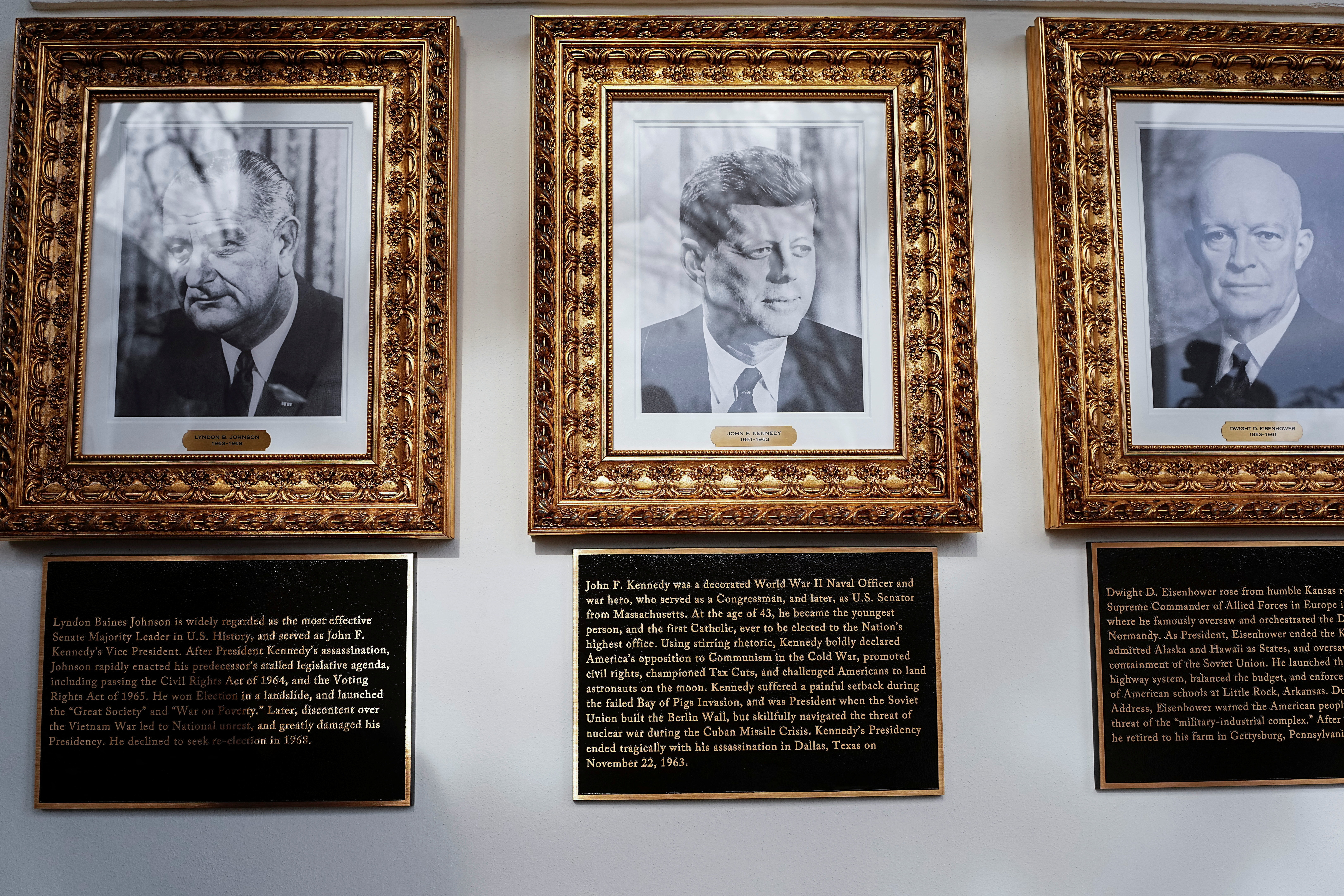 Portraits and plaques dedicated to former U.S. Presidents Lyndon B. Johnson, John F. Kennedy and Dwight D. Eisenhower at the "Presidential Walk of Fame" at the White House, in Washington, D.C., U.S., December 17, 2025. REUTERS/Aaron Schwartz