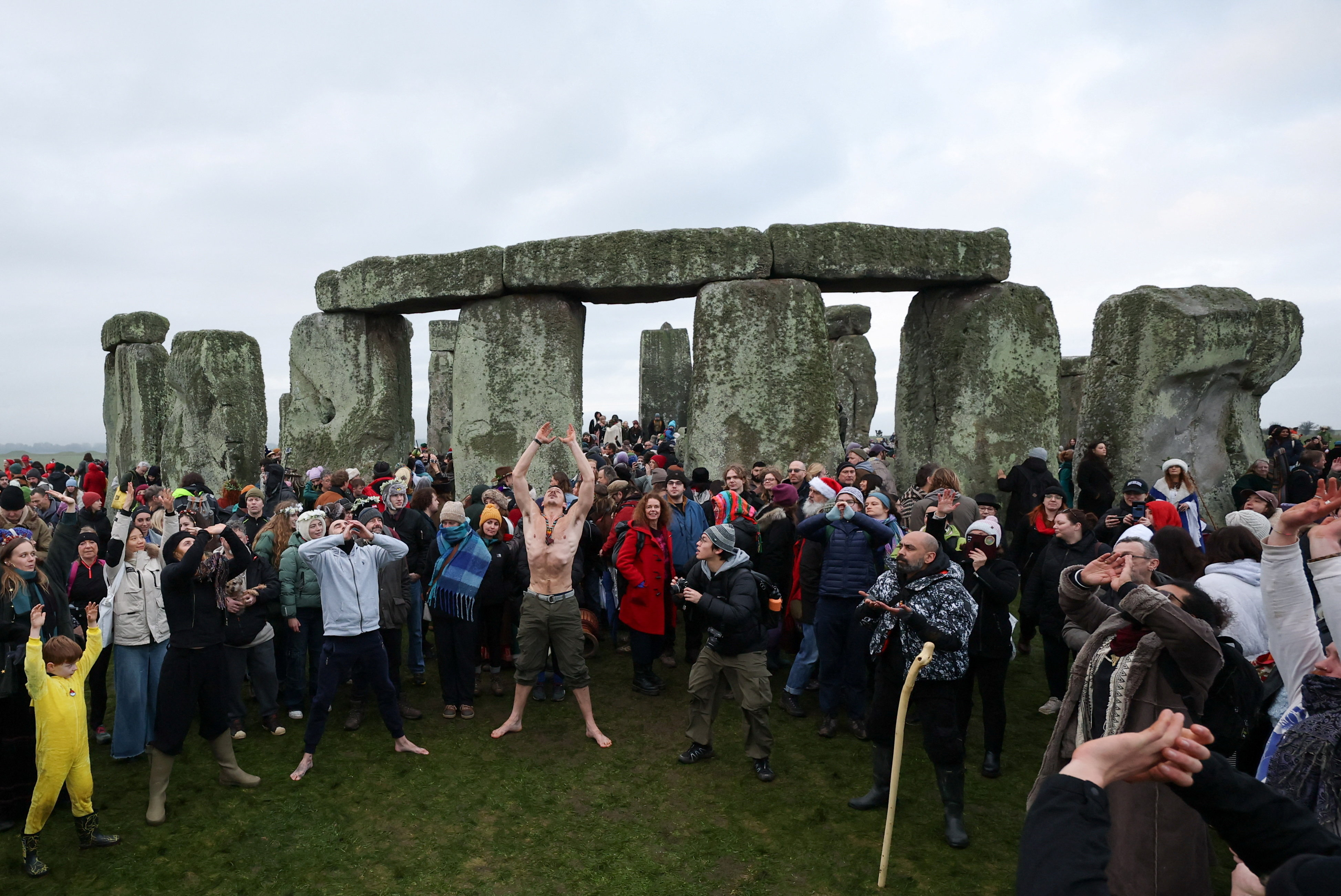 Revellers do yoga as they attend winter solstice celebrations at the Stonehenge stone circle, near Amesbury, Britain, December 21, 2025.