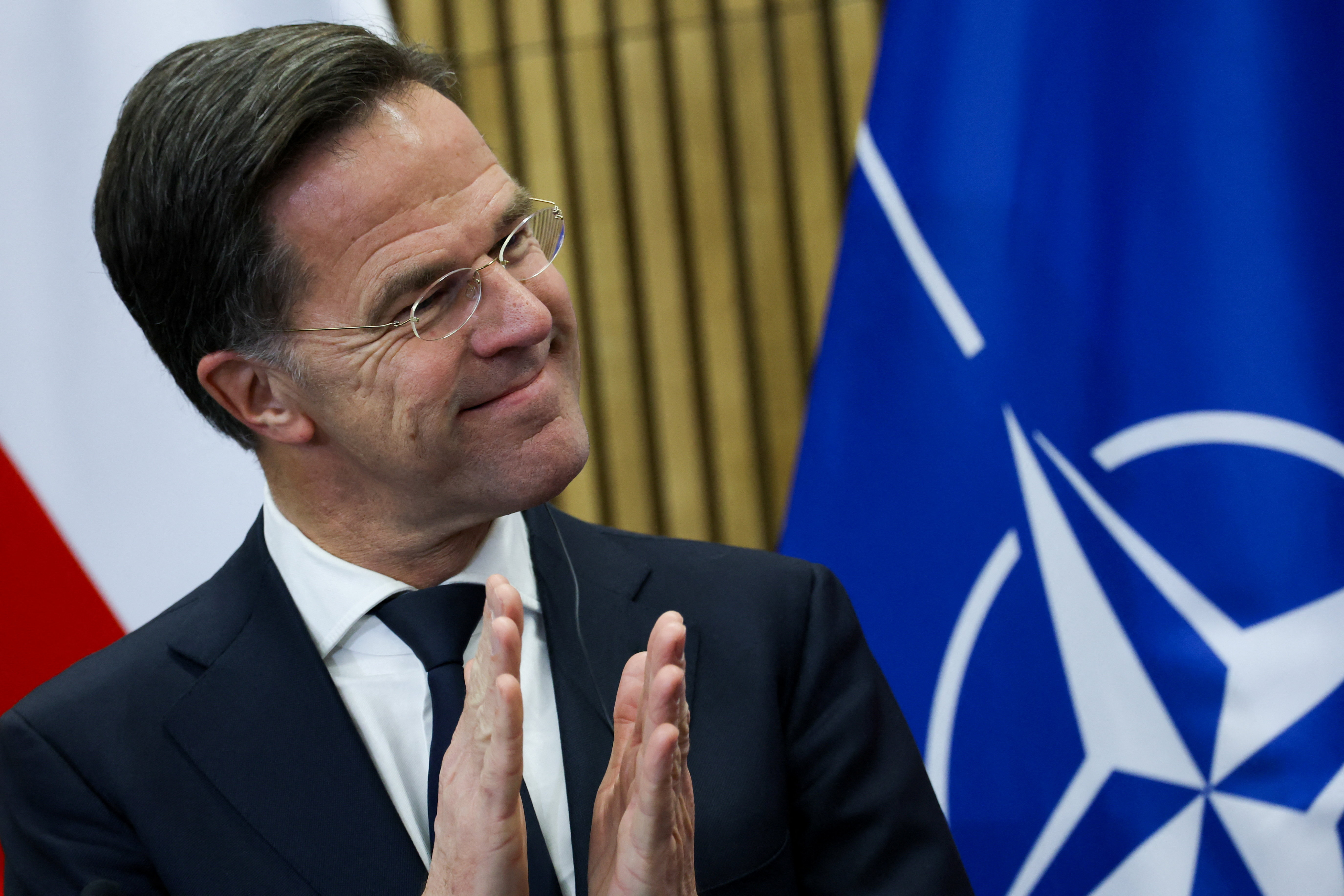 NATO Secretary General Mark Rutte applauds during a press conference, at the Land Forces Training Centre, in Bemowo Piskie near Orzysz, Poland, December 18, 2025. REUTERS/Kacper Pempel