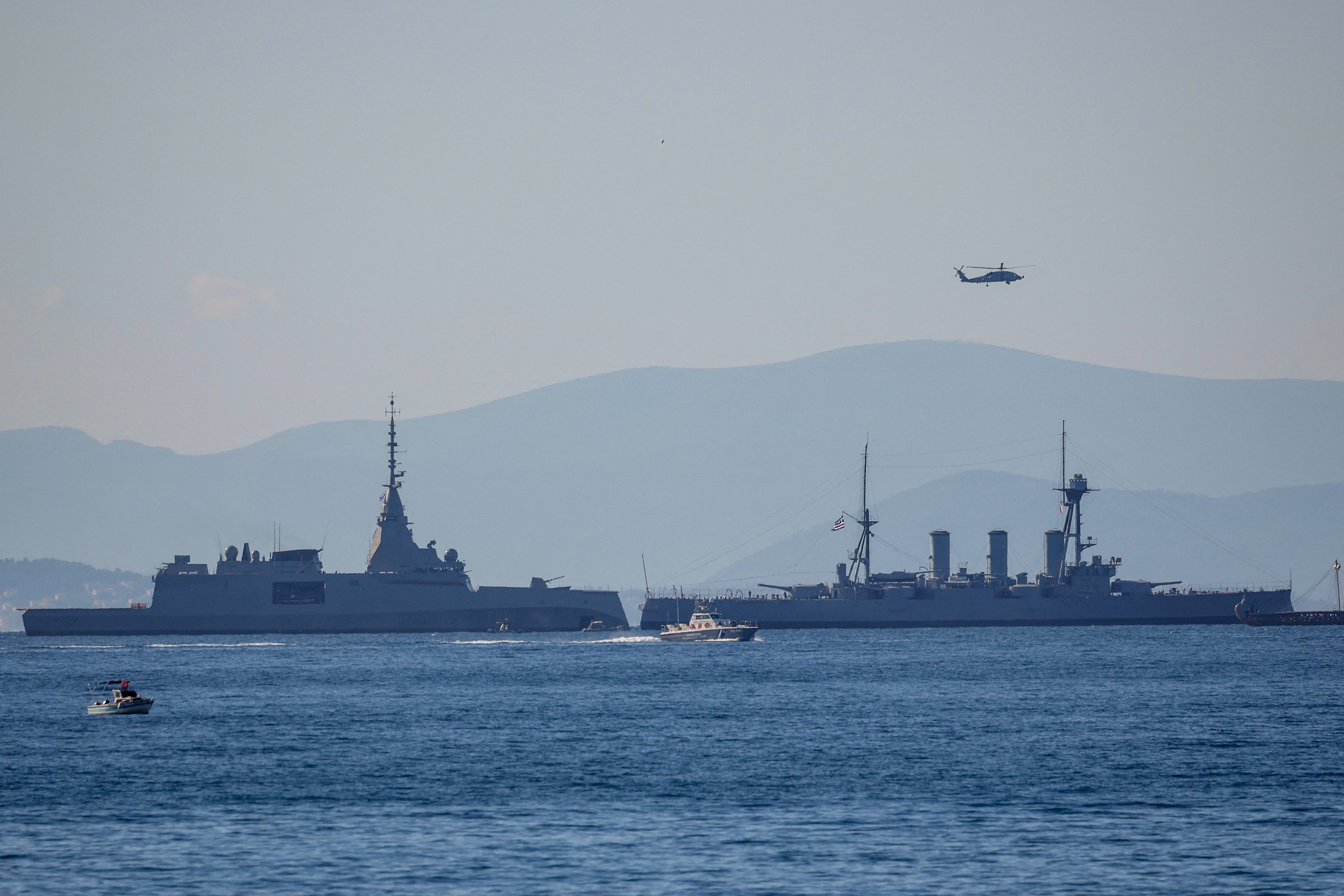 The first of four Belharra frigates, Kimon, purchased from France, sails next to the historic Greek Navy armoured cruiser, Georgios Averof