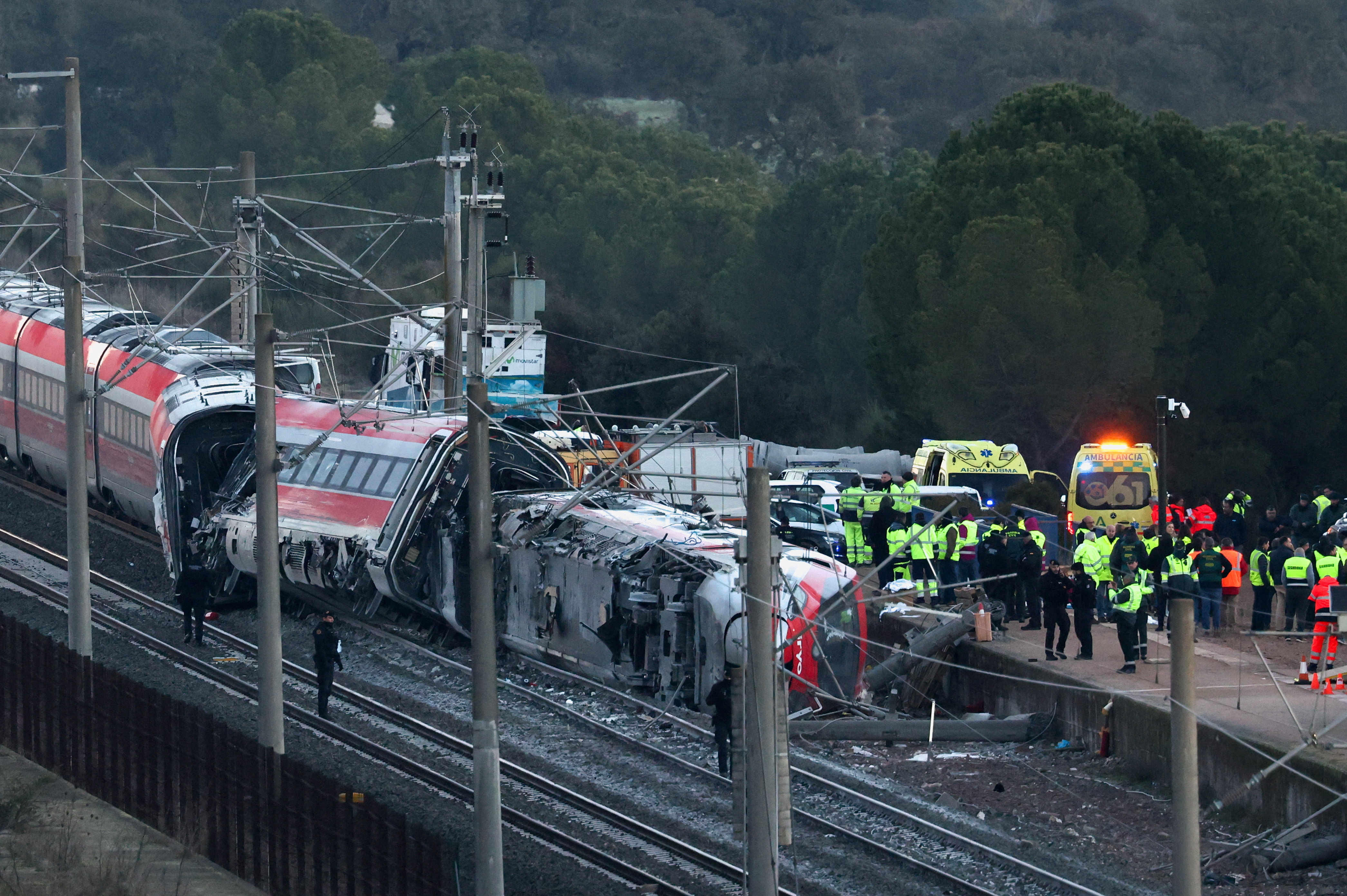 Members of the Spanish Civil Guard along with other emergency personnel work next to one of the trains involved in the accident, at the site of a deadly derailment of two high-speed trains near Adamuz, in Cordoba, Spain