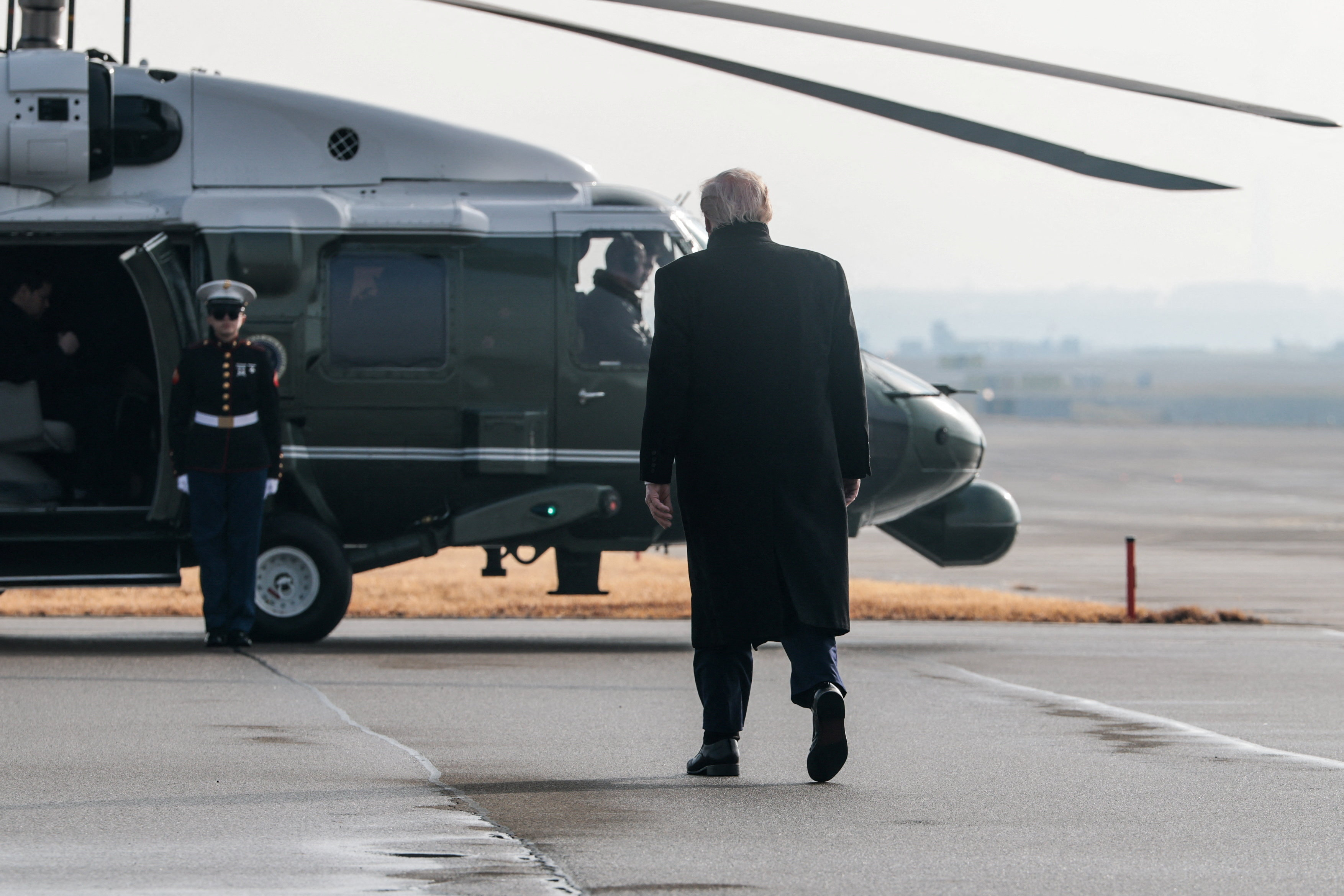 U.S. President Donald Trump walks towards Marine One upon arrival at Zurich International Airport, as he travels to attend the World Economic Forum in Davos, in Zurich, Switzerland January 21, 2026. REUTERS/Jonathan Ernst