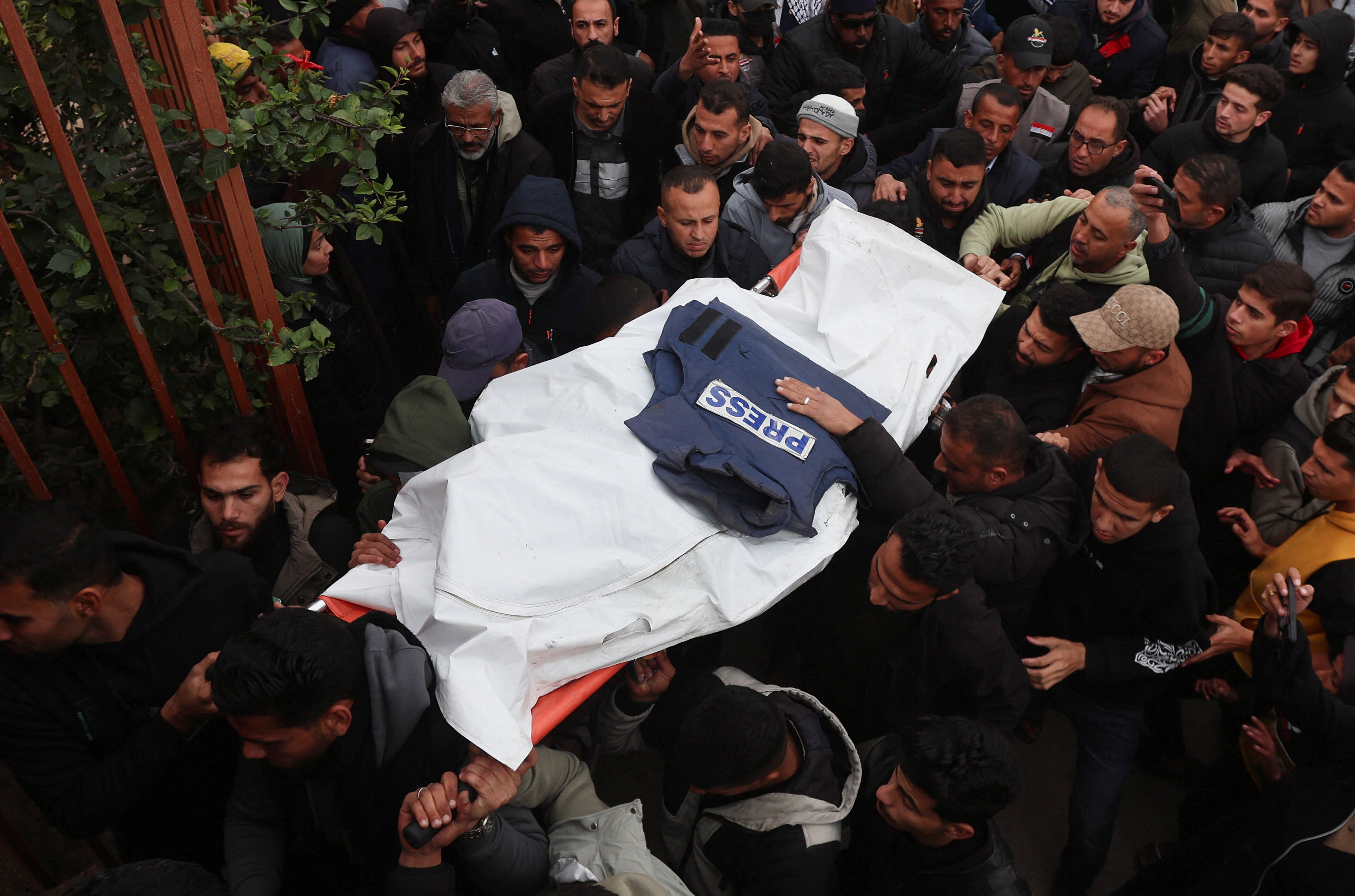 Mourners carry the body of one of the Palestinian journalists killed in an Israeli airstrike on Wednesday, in Khan Younis, in the southern Gaza Strip, January 21, 2026.