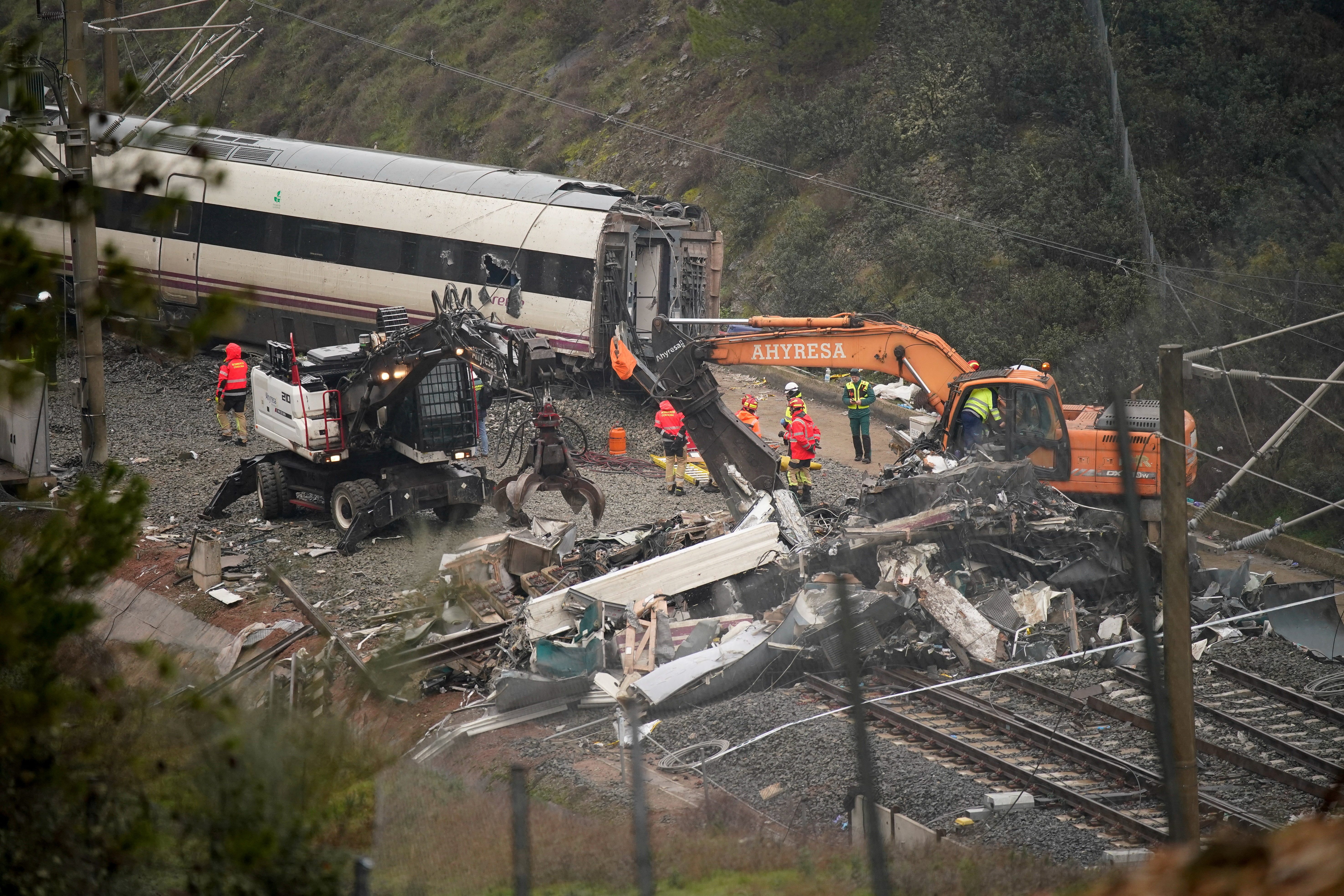 Workers operate heavy machinery as removal works continue following a deadly derailment of two high-speed trains near Adamuz, in Cordoba, Spain