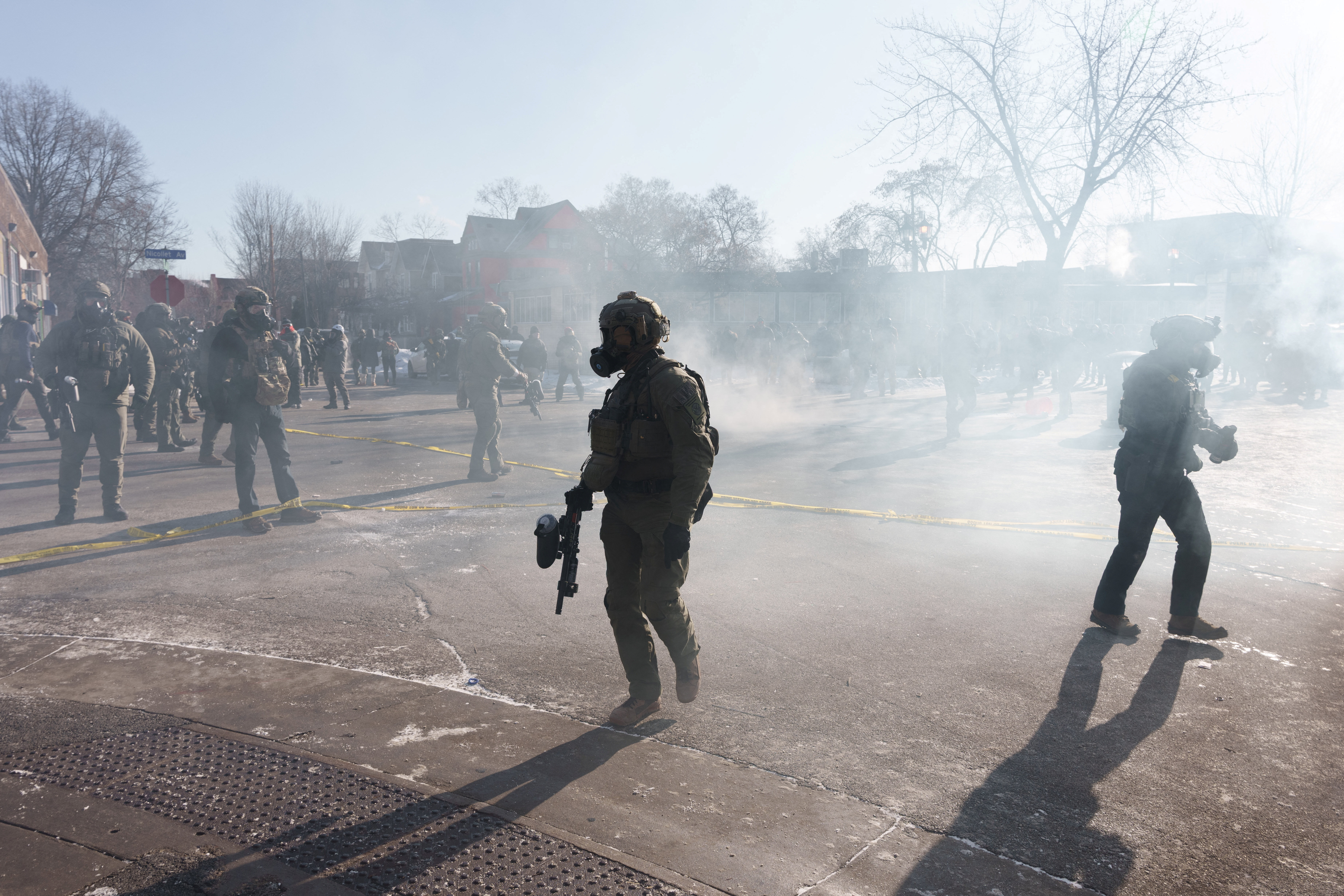 Federal agents walks through a cloud of teargas near the site where a man identified as Alex Pretti was fatally shot by federal agents trying to detain him, in Minneapolis, Minnesota, U.S., January 24, 2026.REUTERS/Tim Evans