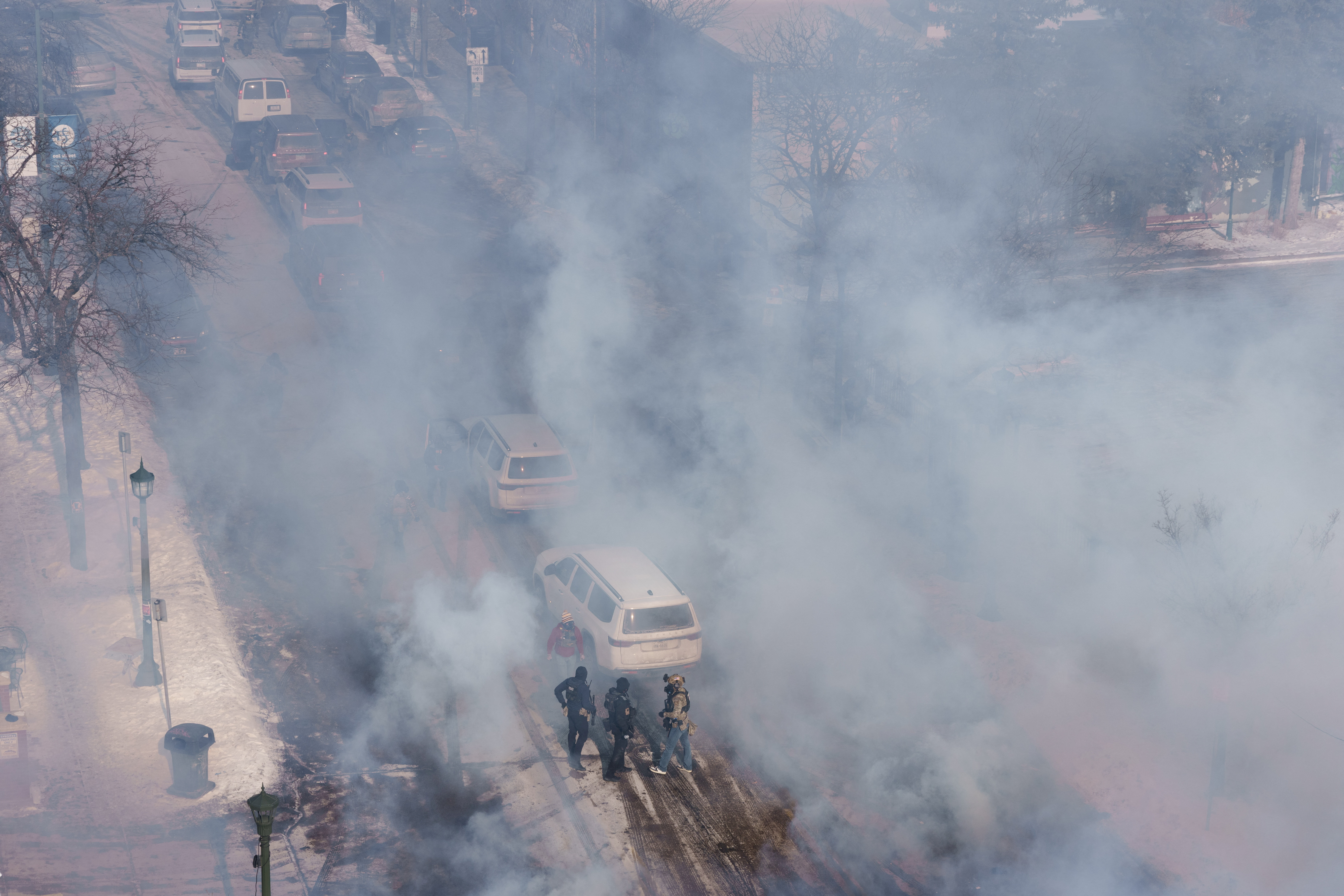 Federal agents stand amid a massive cloud of teargas near the site where a man identified as Alex Pretti was fatally shot by federal agents trying to detain him, in Minneapolis, Minnesota, U.S., January 24, 2026. REUTERS/Tim Evans