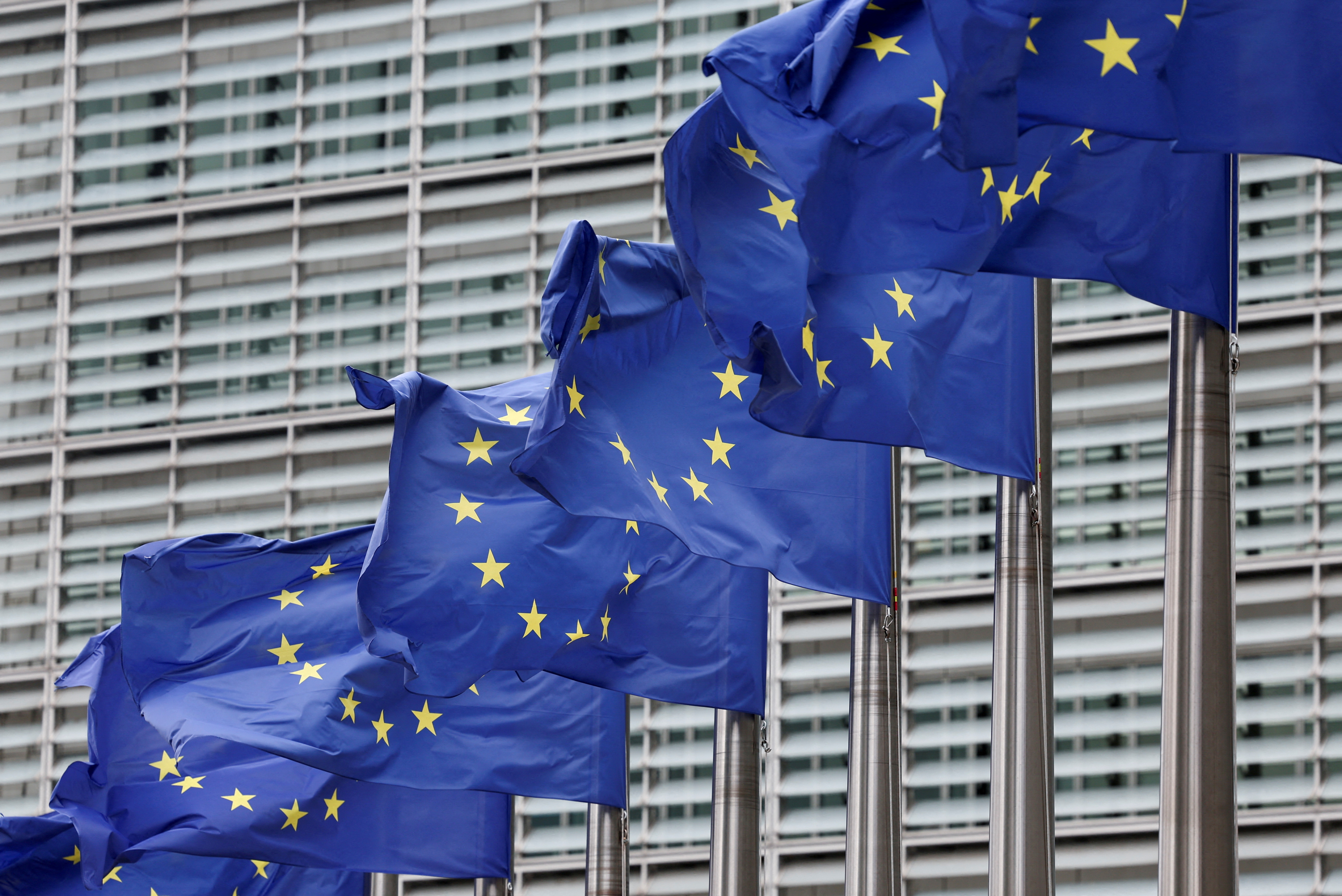 FILE PHOTO: European Union flags flutter outside the EU Commission headquarters in Brussels, Belgium July 16, 2025. REUTERS/Yves Herman/File Photo