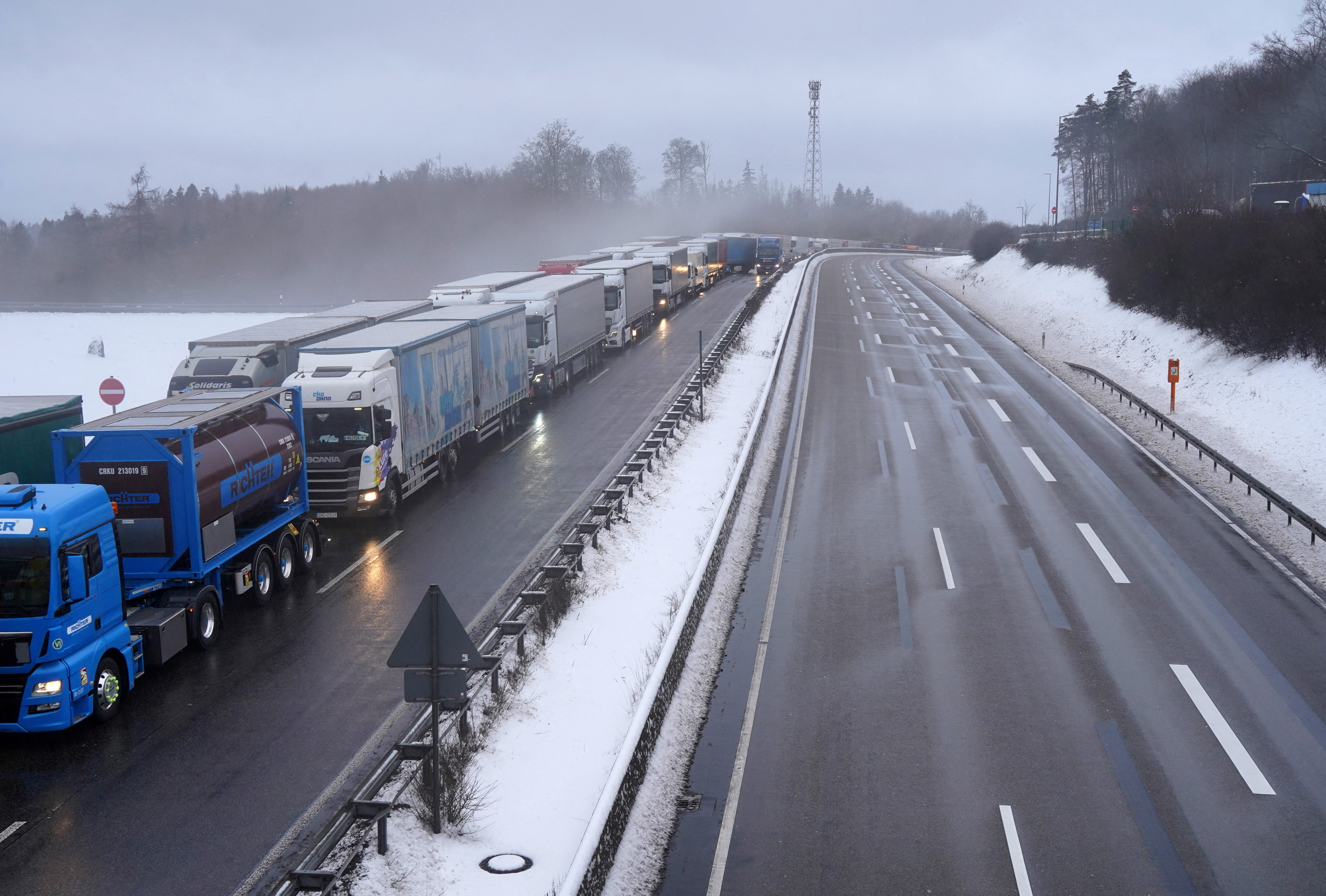 Trucks are stuck in traffic on the A5 highway as the country faces heavy snowfall and disruptions to air and train traffic near Breitenbach, Germany, January 9, 2026.