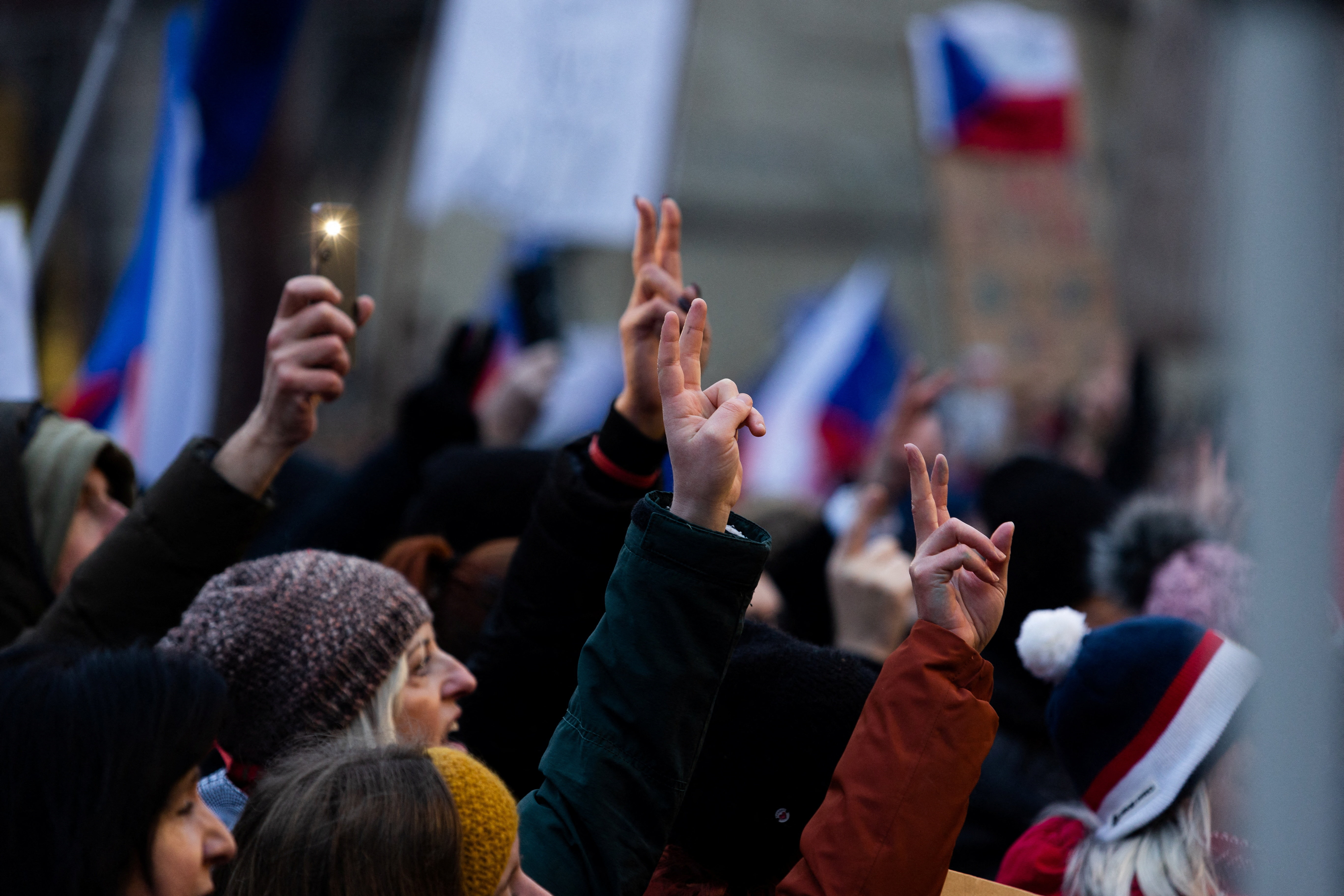 People gesture as they take part in a rally in support of Czech President Petr Pavel, organised by Million Moments for Democracy group in reaction to dispute between President Pavel and Czech Foreign Minister and Motorists chair Petr Macinka