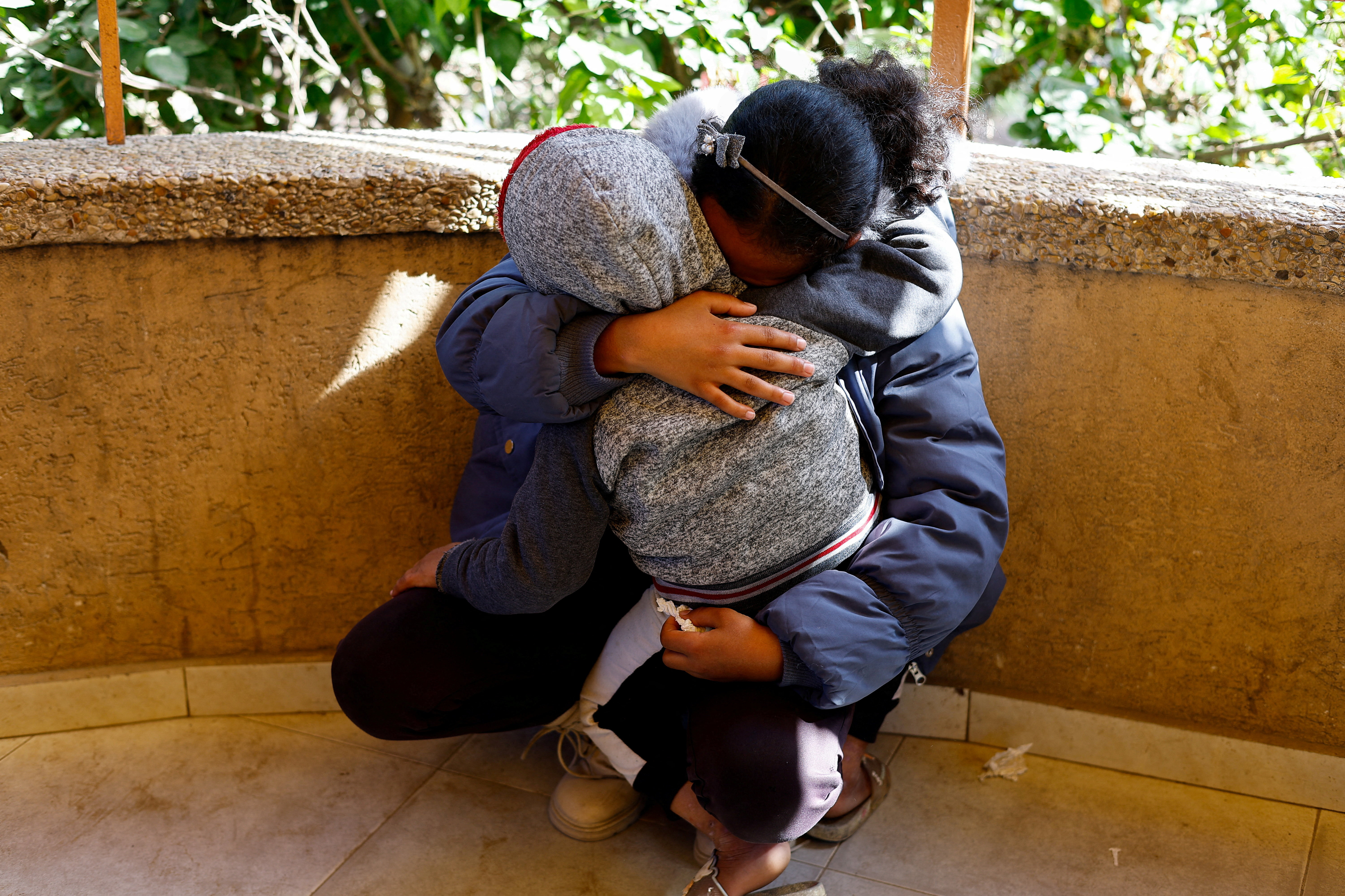 Mourners react during the funeral of Palestinians killed on Wednesday in an Israeli strike on a tent camp sheltering displaced people, at Nasser hospital in Khan Younis