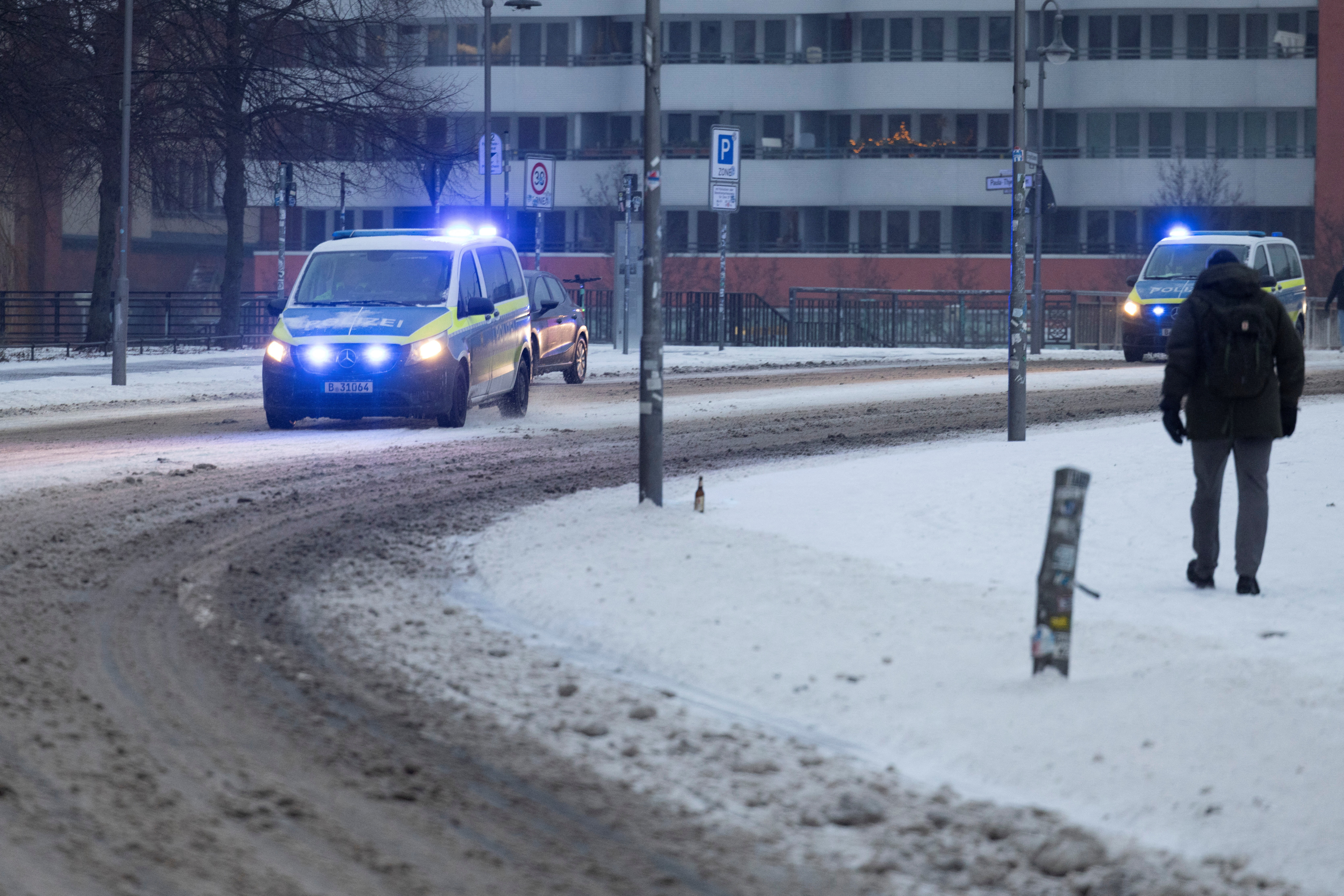Police patrol cars drive along snow-covered roads in Berlin, Germany, February 5, 2026. REUTERS/Axel Schmidt