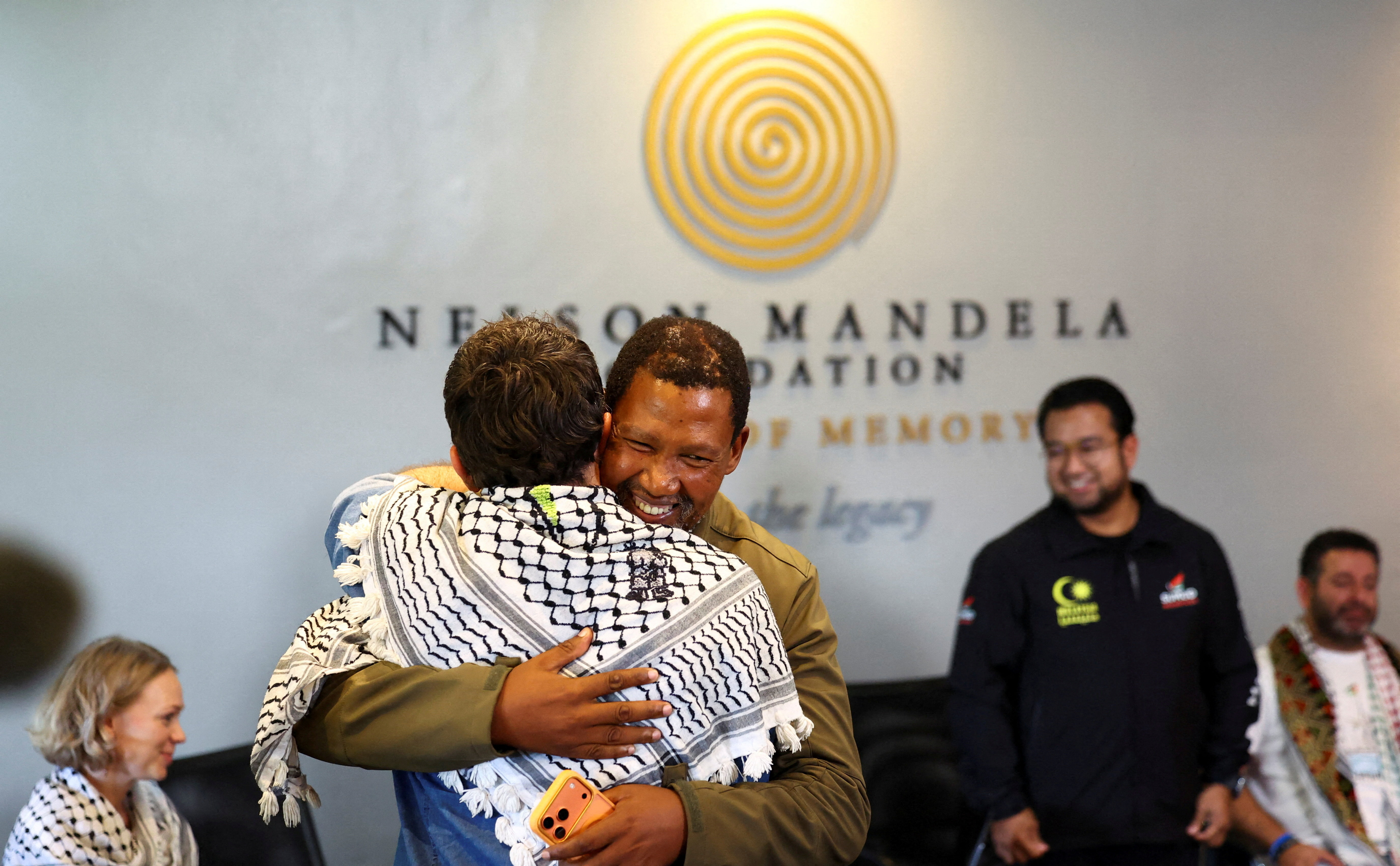 Mandla Mandela, grandson of South Africa's first democratically elected president Nelson Mandela, greets members of the Global Sumud Flotilla activist group ahead of a meeting on 2026 plans at the Nelson Mandela Foundation in Houghton