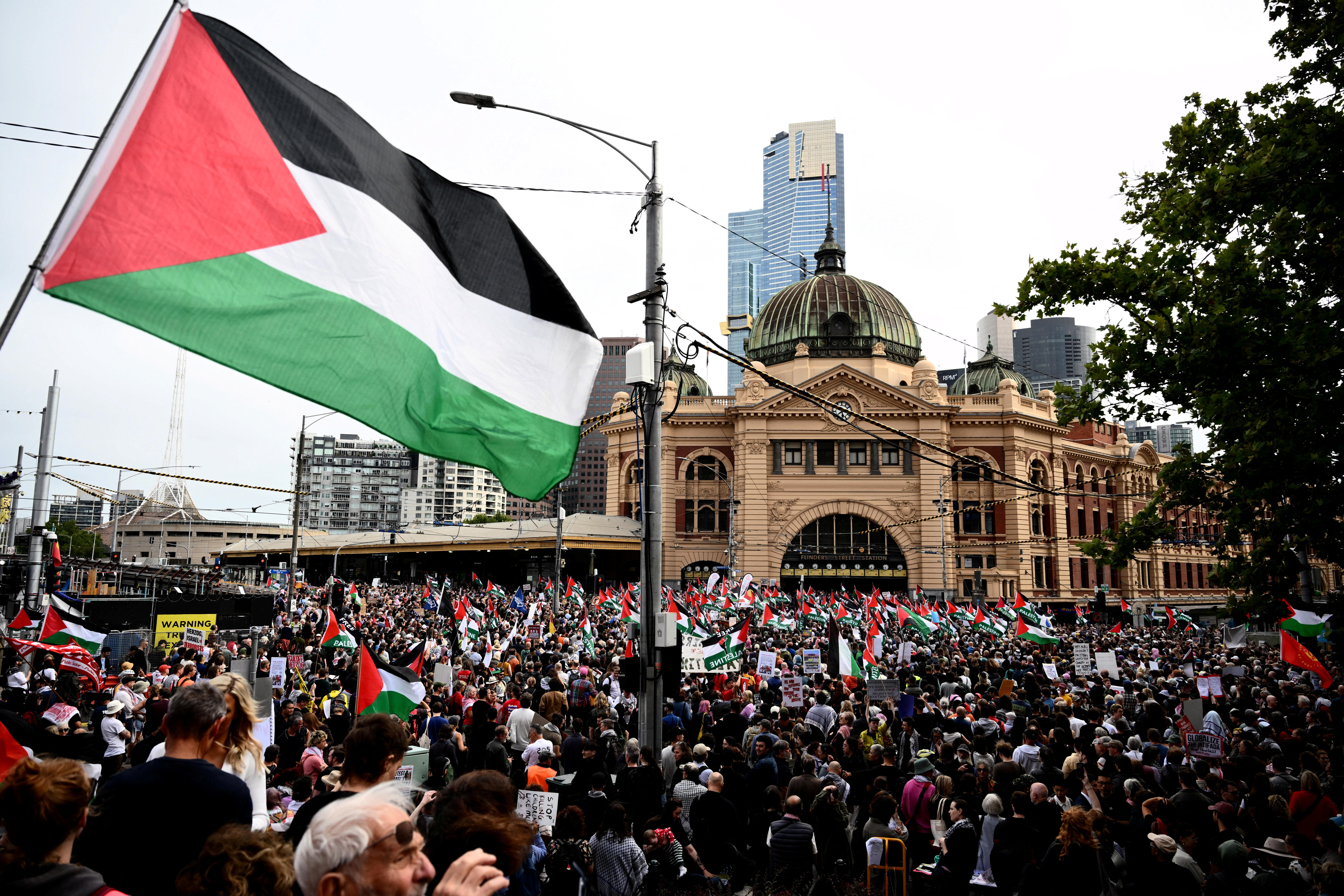 Demonstrators gather during a protest against Israeli President Isaac Herzog's visit to Australia, at Flinders Street Station in Melbourne