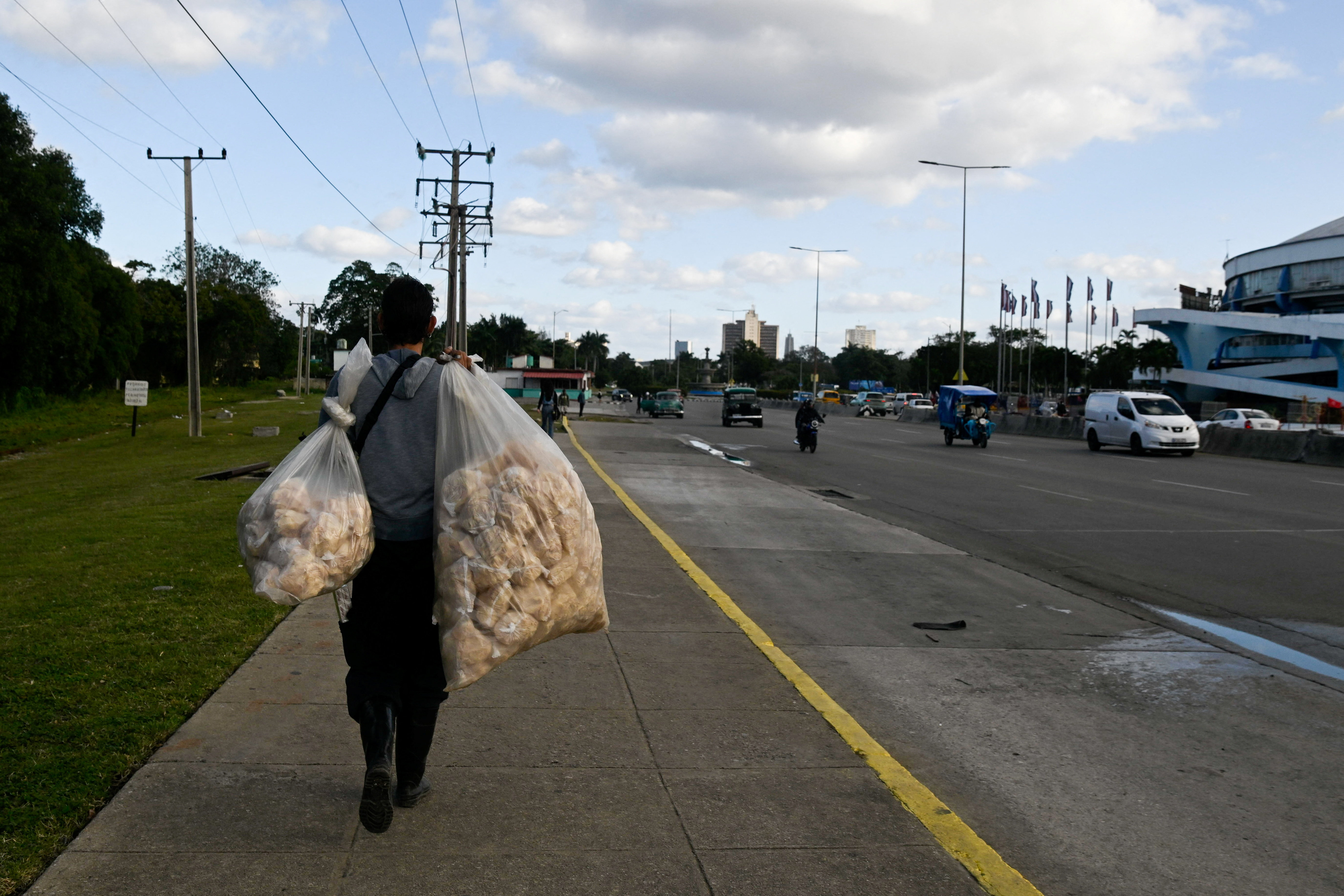 A man carries pork rinds to sell as Cubans brace for fuel scarcity measures after U.S. tightens oil supply blockade, in Havana, Cuba