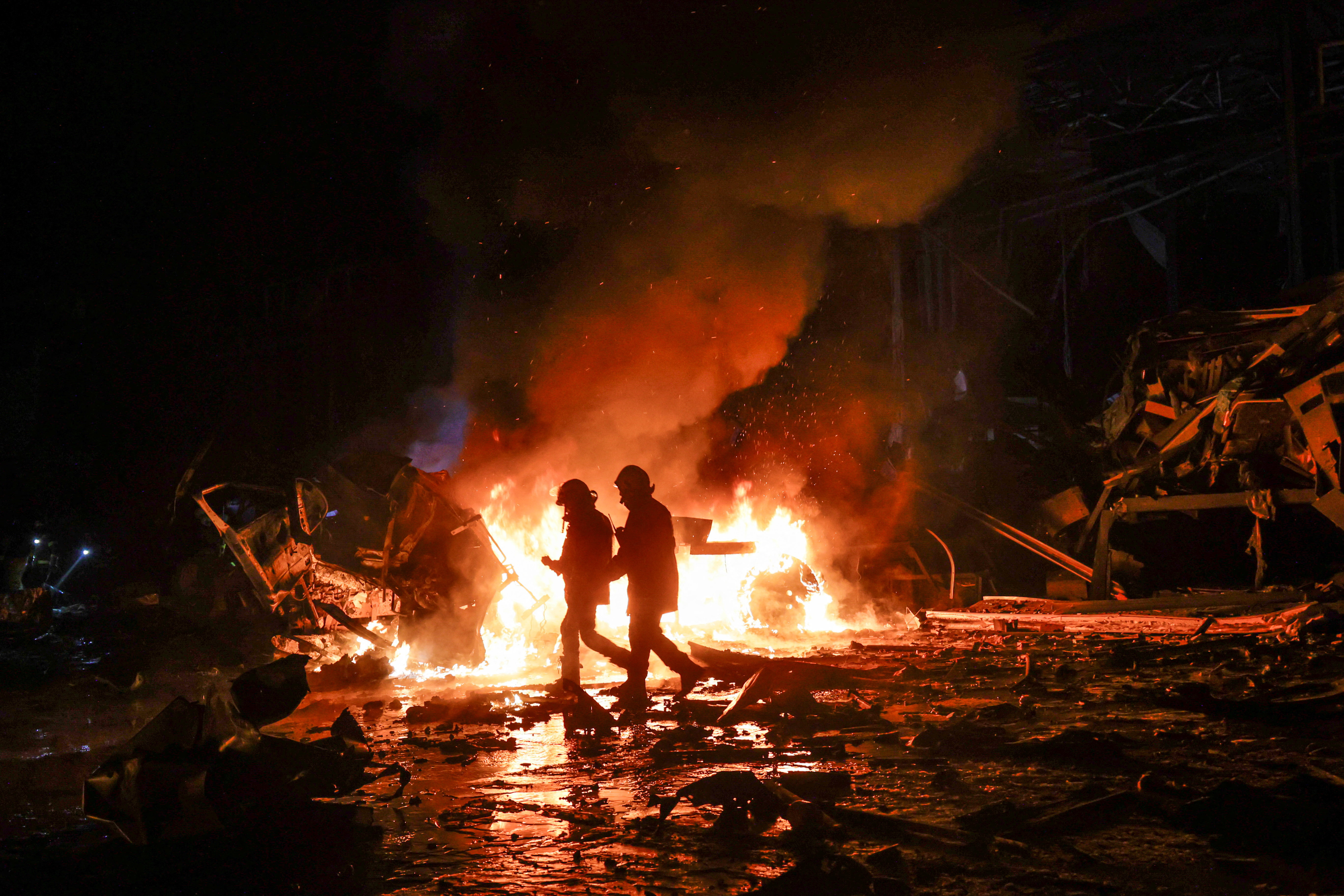 Firefighters work at the site of a logistics hub of a private delivery company hit by Russian missile strikes, amid Russia's attack on Ukraine, in Kharkiv, Ukraine January 13, 2026. REUTERS/Sofiia Gatilova