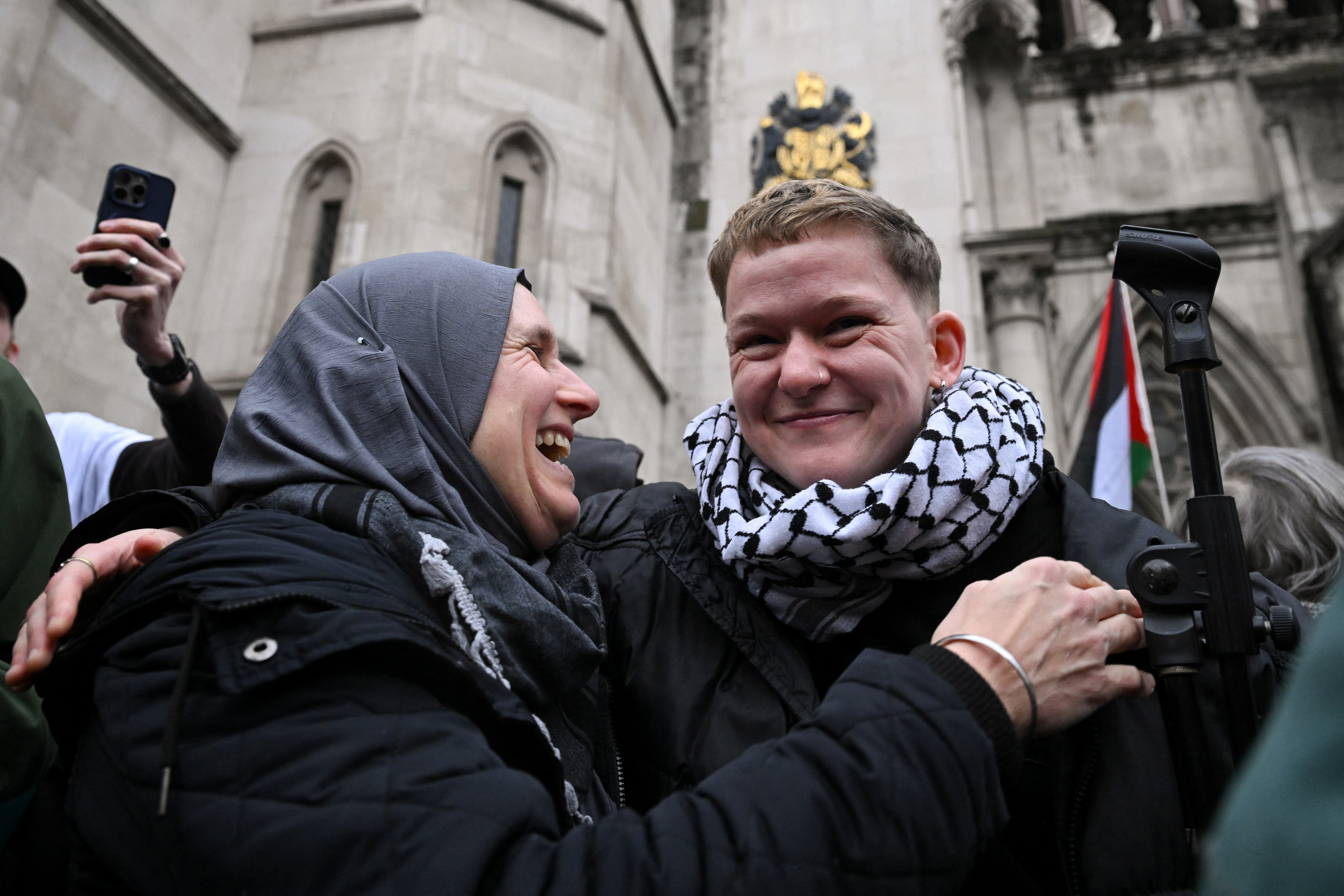 People react outside the Royal Courts of Justice, after High Court judges ruled the British government’s decision to designate pro‑Palestinian group Palestine Action as a terrorist organisation unlawful