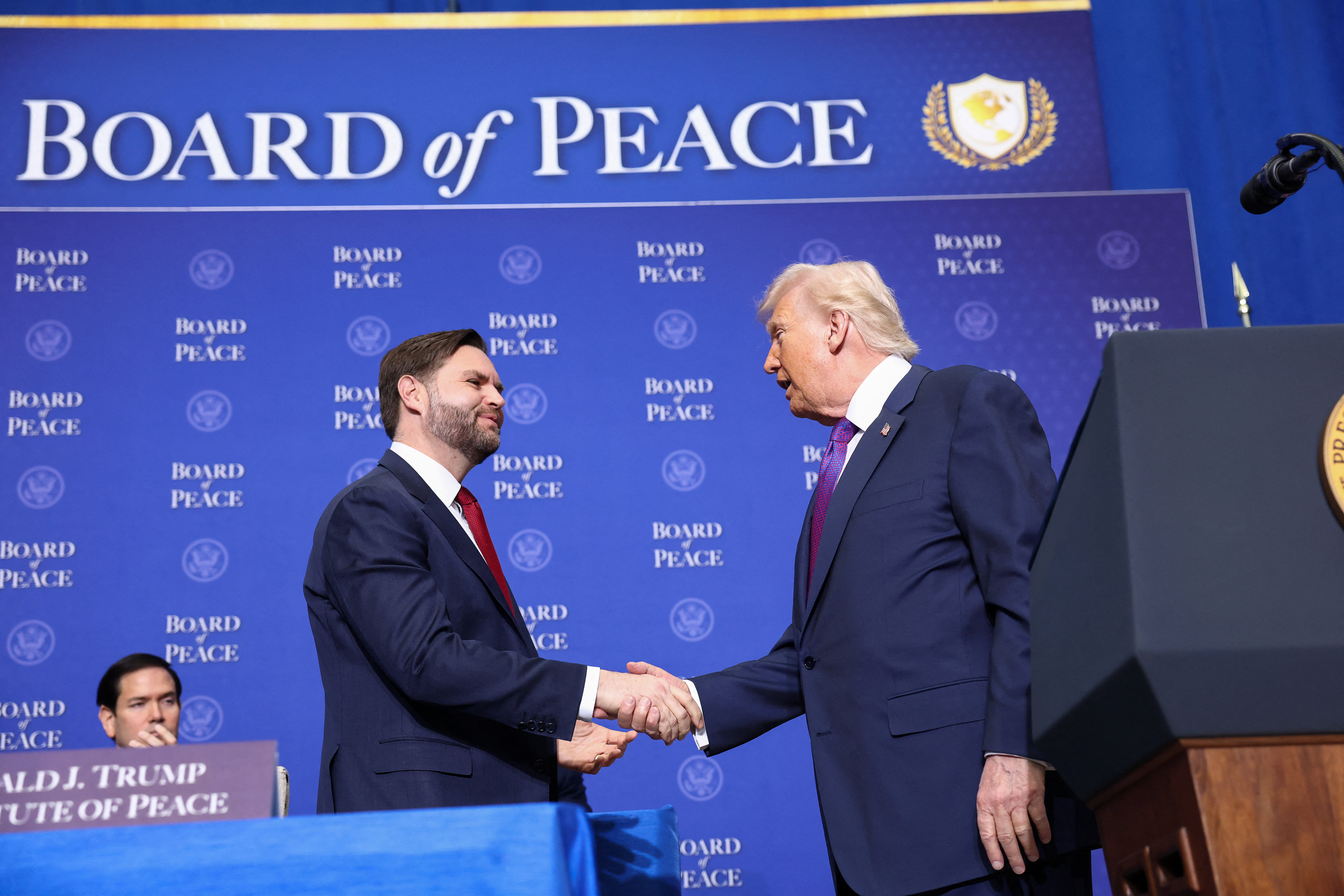 U.S. Vice President JD Vance shakes hands with President Donald Trump, as they and Secretary of State Marco Rubio attend the inaugural Board of Peace meeting at the U.S. Institute of Peace in Washington, D.C., U.S.